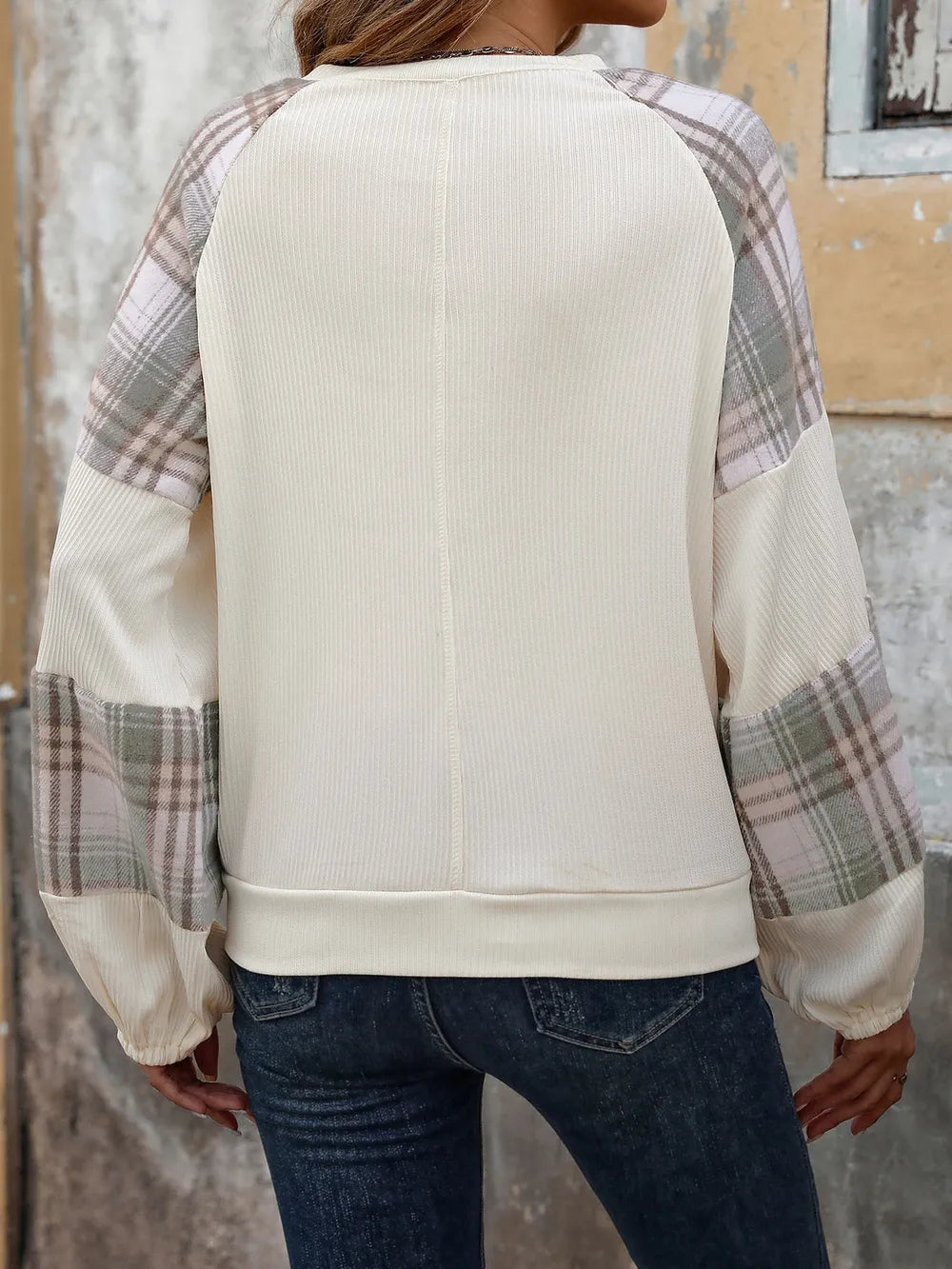 Cream sweatshirt with plaid raglan sleeves, round back