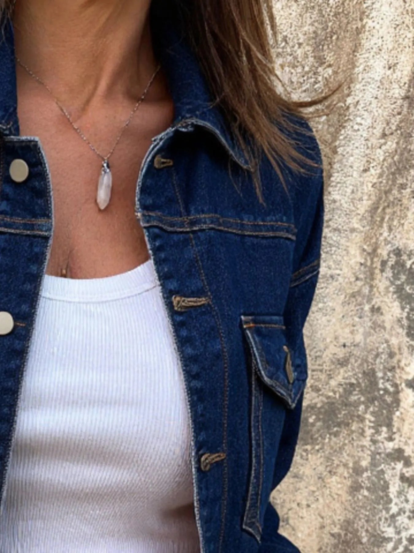 Blue denim jacket with buttoned shoulder yoke and flap chest pocket detail