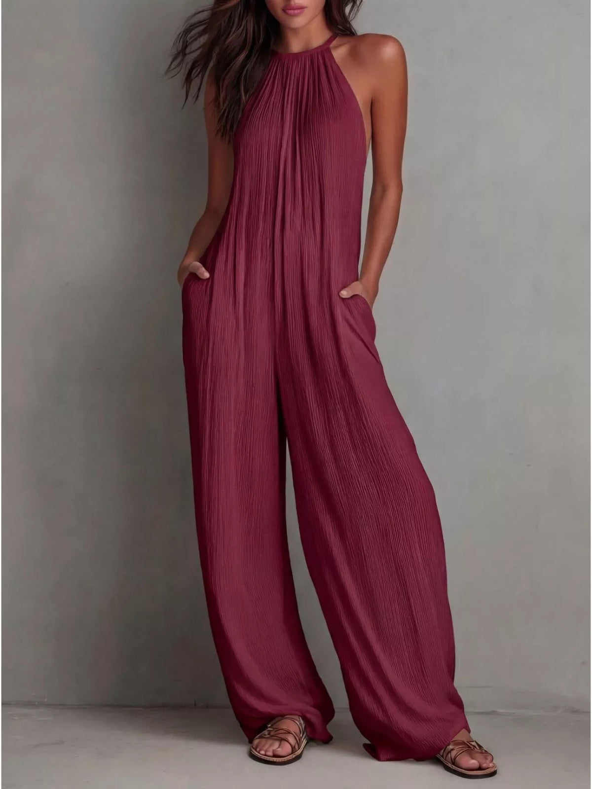 Sleeveless wide-leg jumpsuit in maroon, halter neckline with gathered pleats and drape