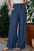 Peacock blue wide-leg pants with pockets, elastic waist, denim look.