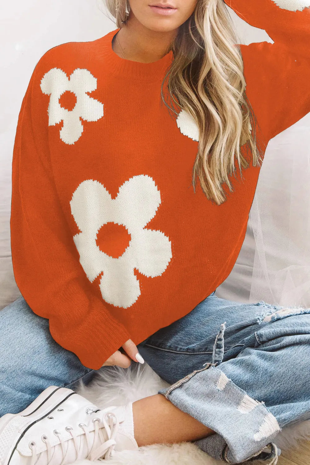 Orange long-sleeve sweater with round neck and white flower pattern