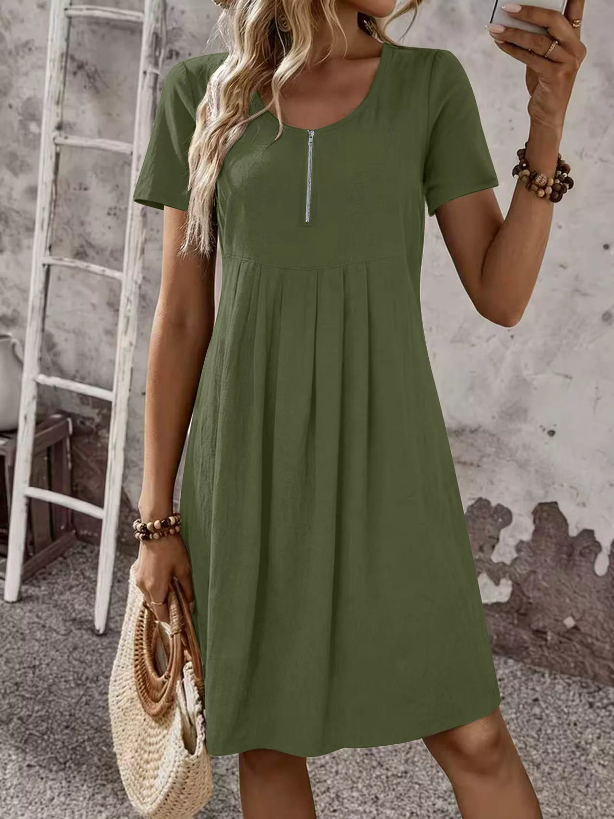 Olive green short-sleeve pleated dress with front zipper and scoop neckline