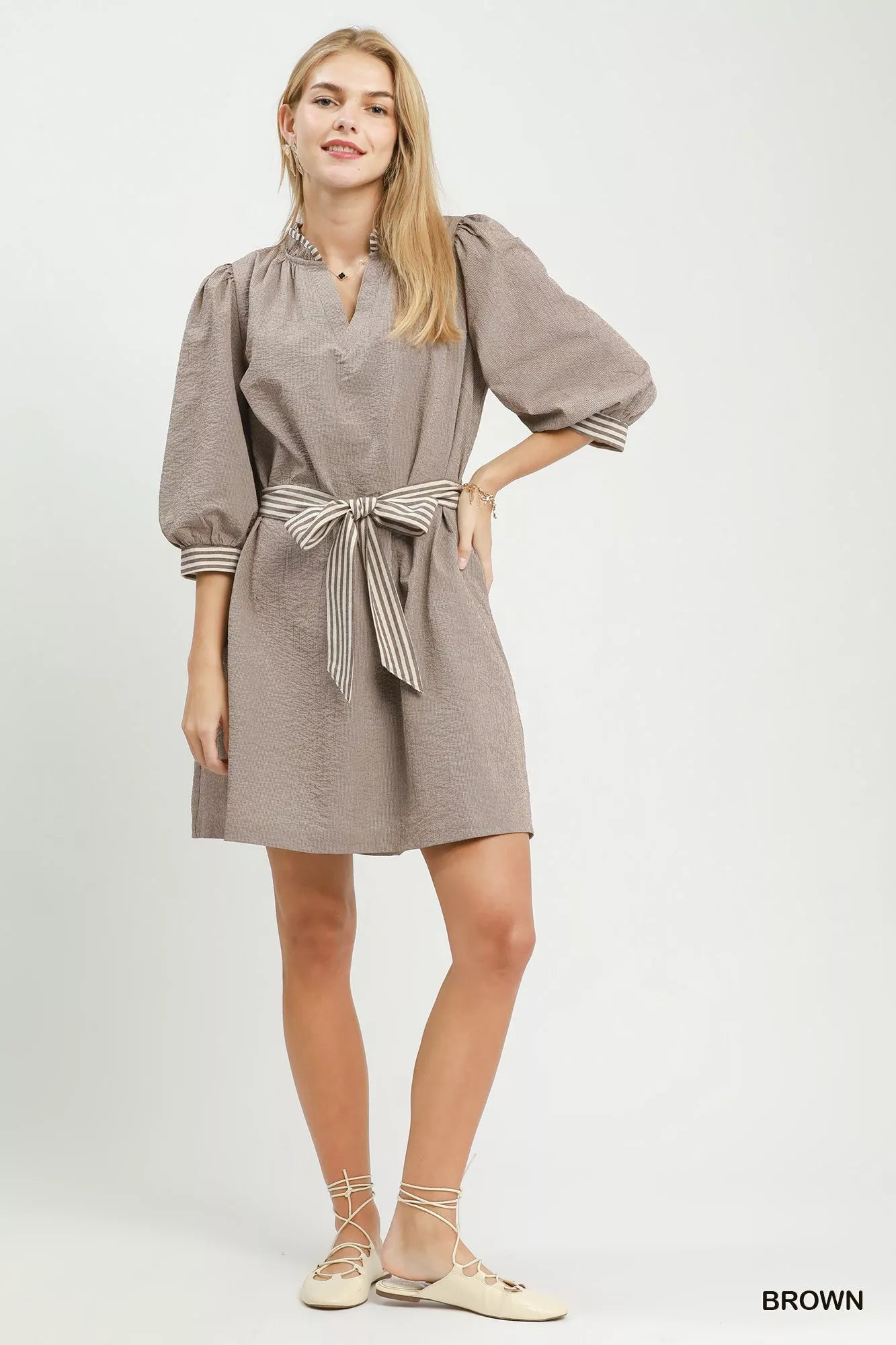 Brown textured mini dress with tie waist belt and striped contrast trim at cuffs; front view