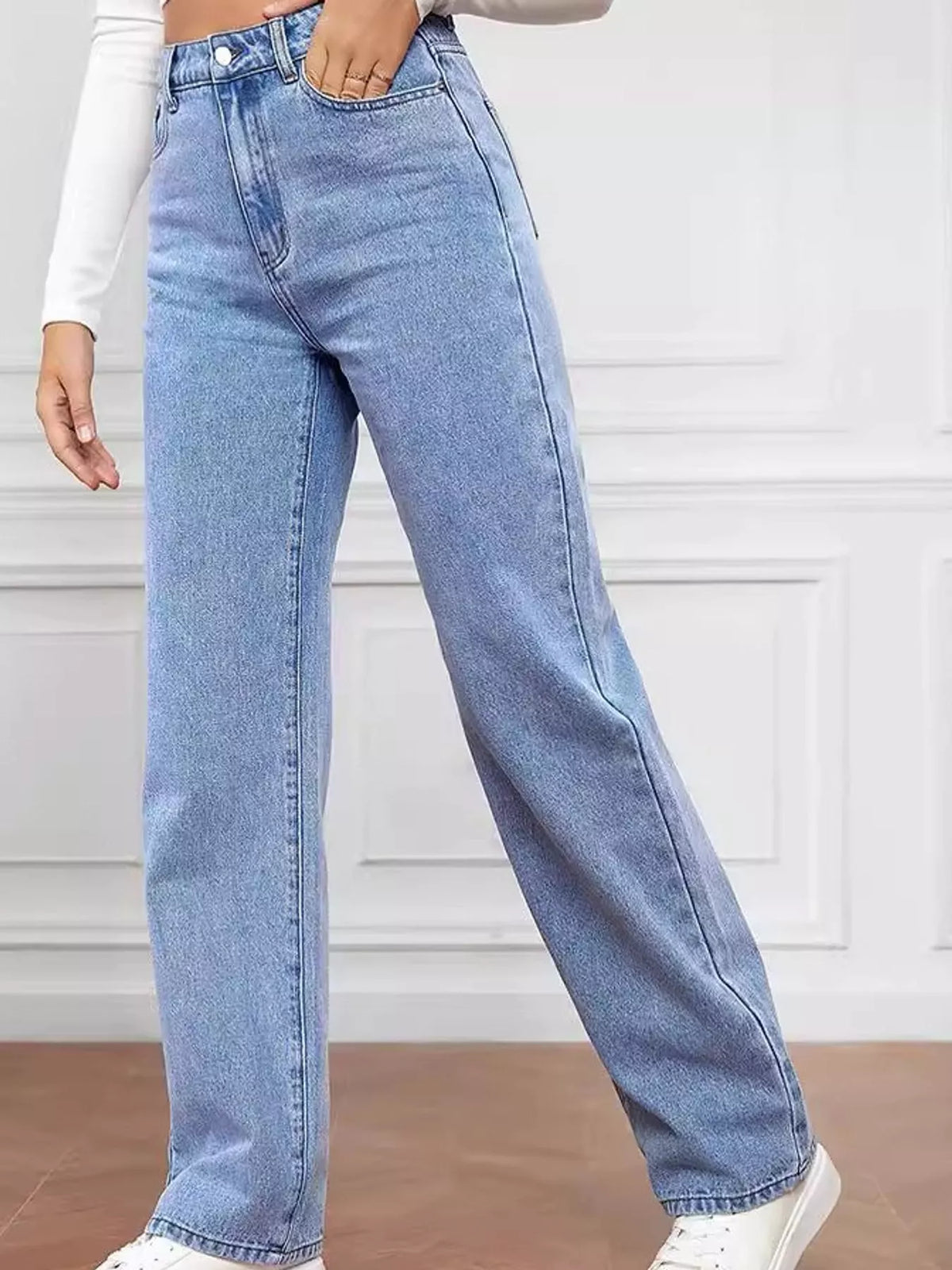 High-waisted vintage wash denim jeans with front seam detailing and wide straight leg