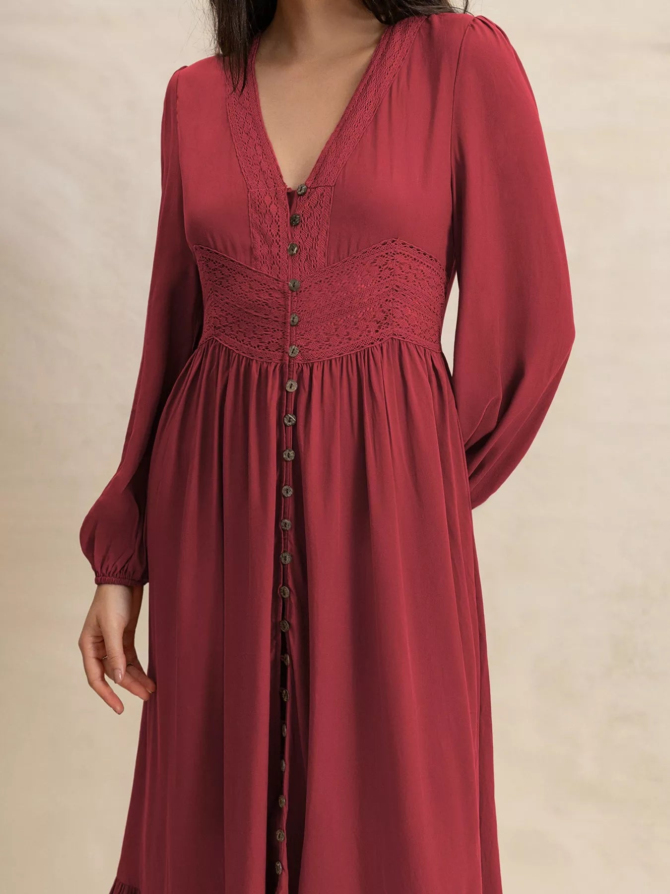 Burgundy V-neck maxi dress close-up with button-front detailing and gathered waist