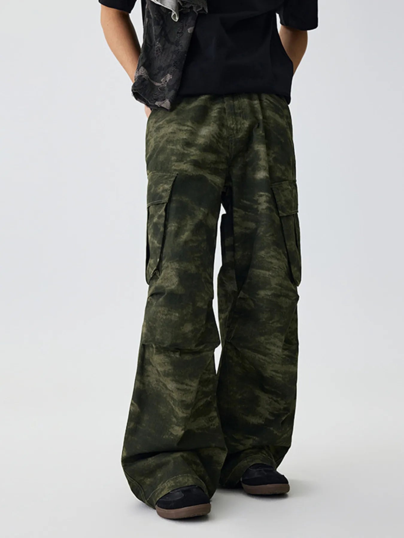 Green camouflage cargo pants with side cargo pockets and baggy wide legs