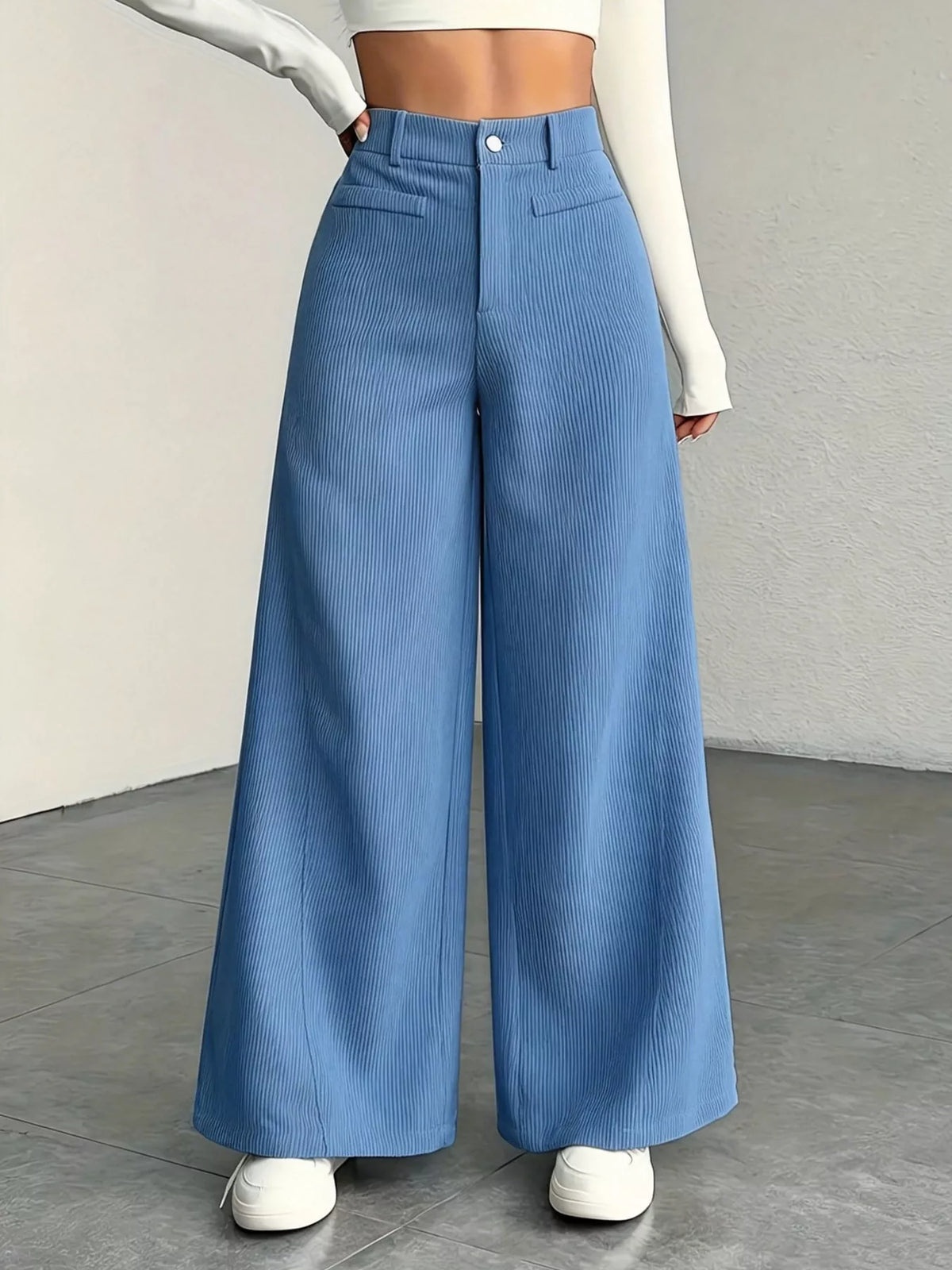 Light blue high-waisted wide-leg pants with pockets and button front