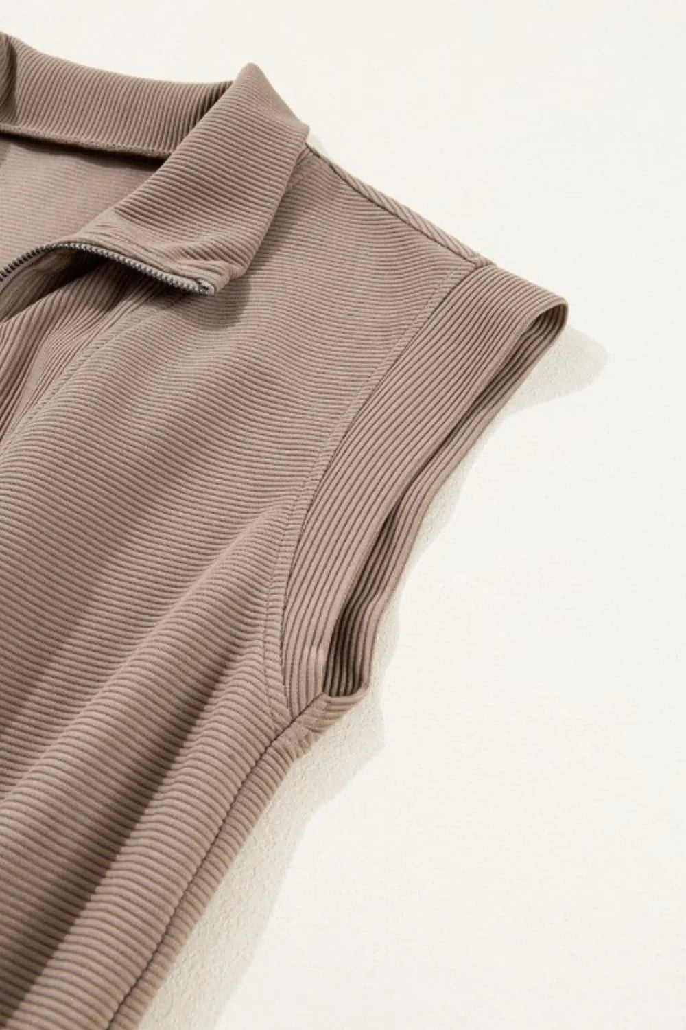 Mocha textured knit fabric of a short-sleeve romper, half-zip placket