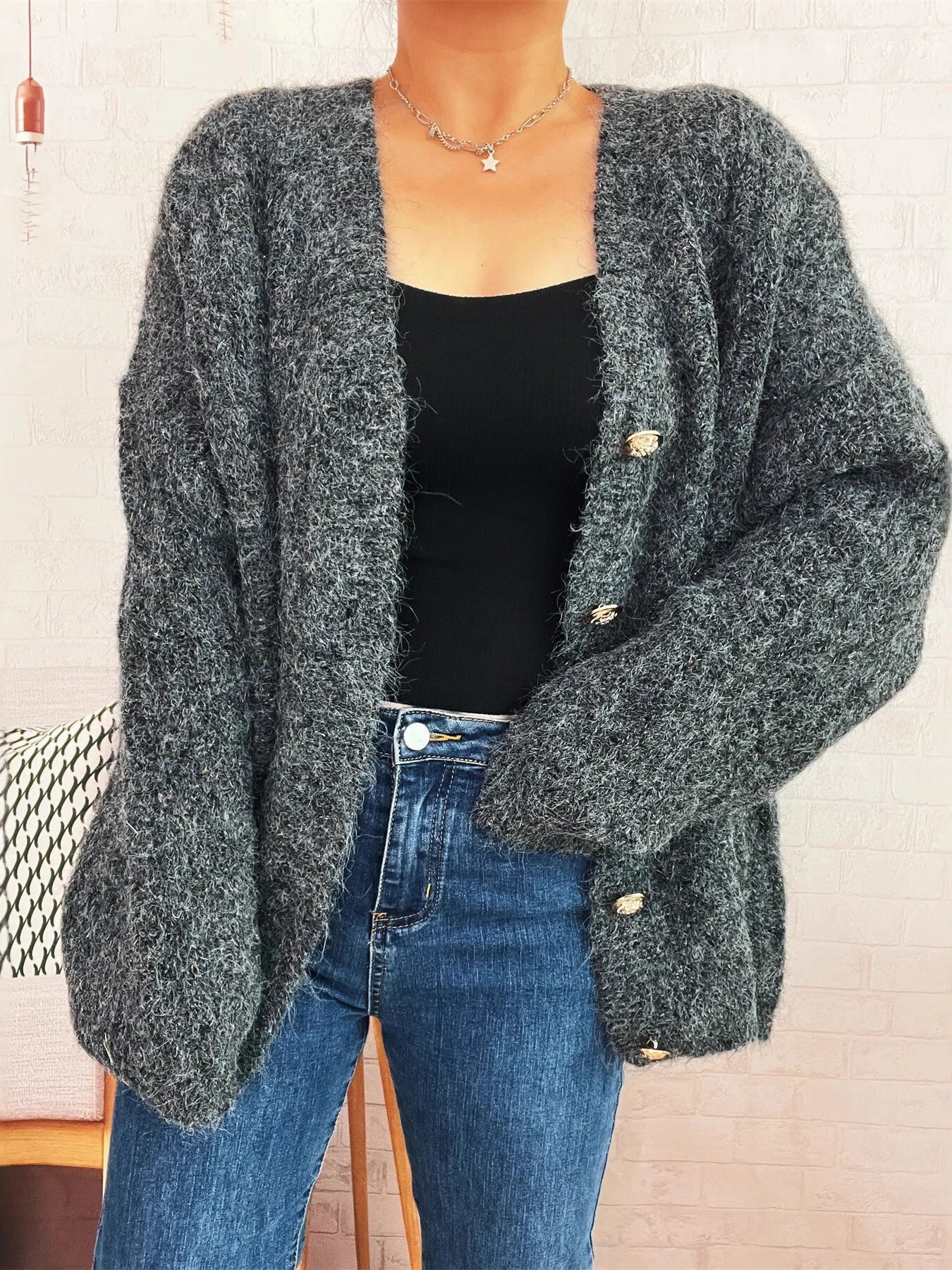 Dark gray knit button-up cardigan with V-neck, long sleeves, and gold buttons