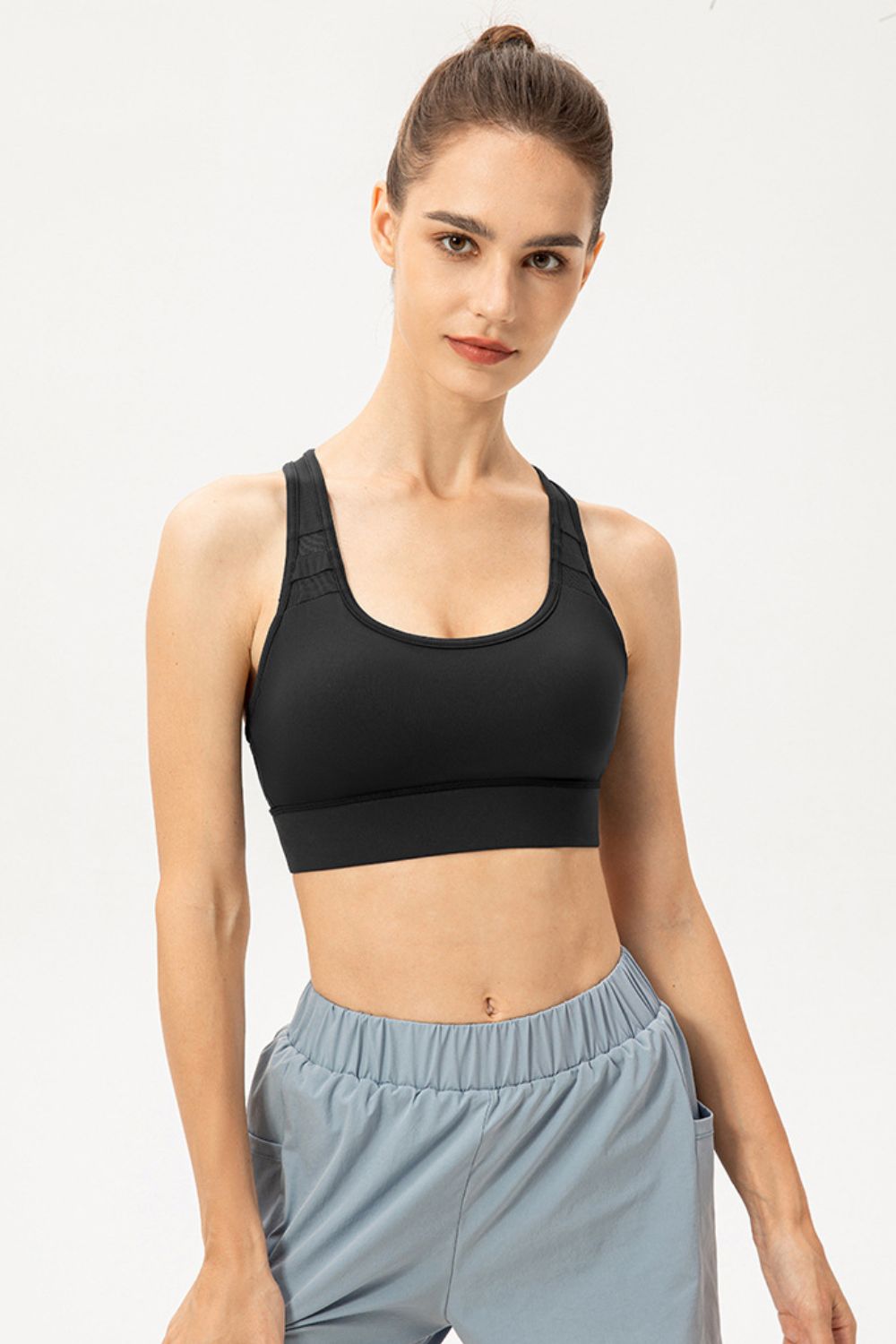 Black longline sports bra with scoop neckline and wide underband