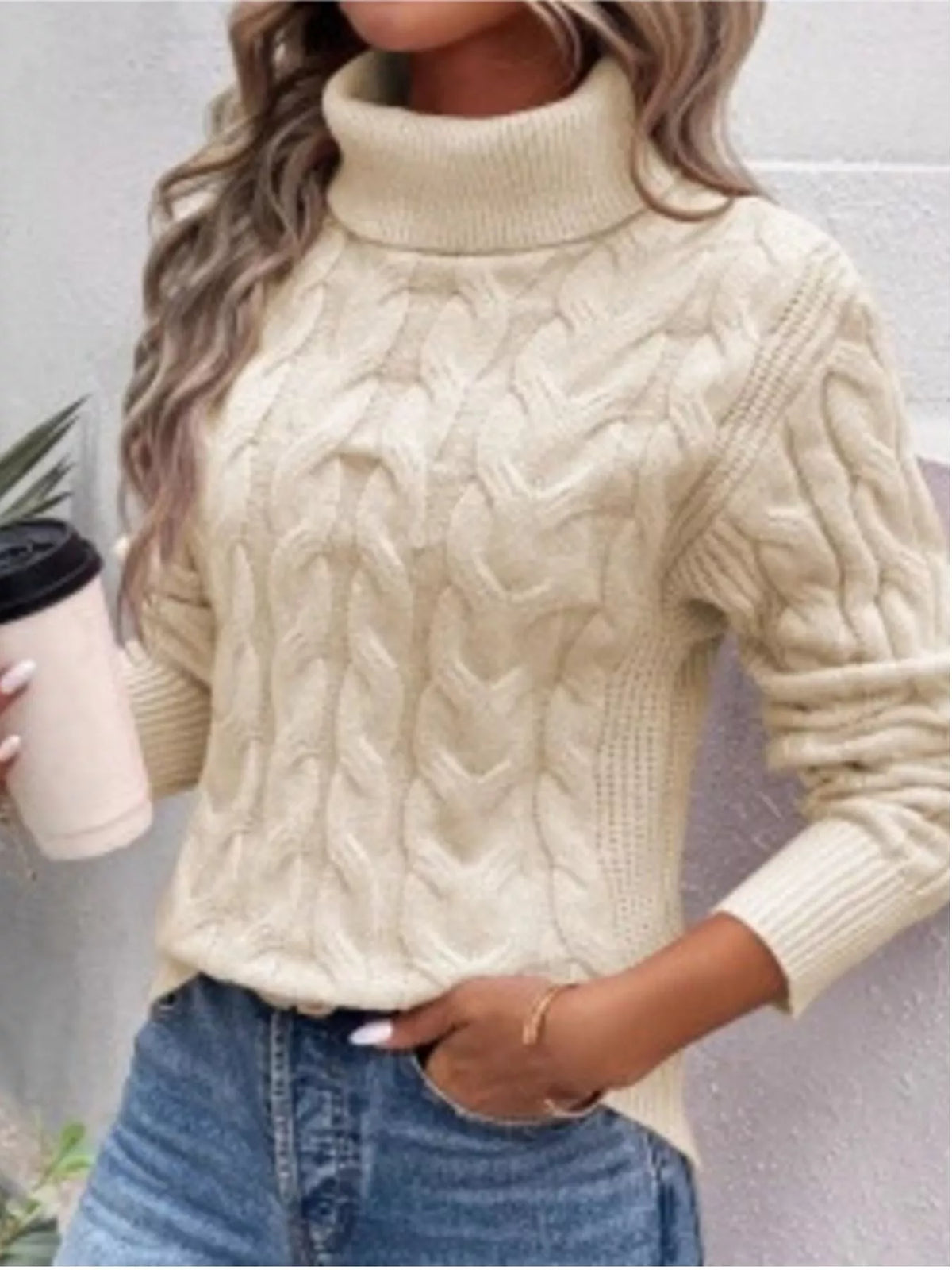 Cream cable knit turtleneck sweater with long sleeves and raised diamond-like cables