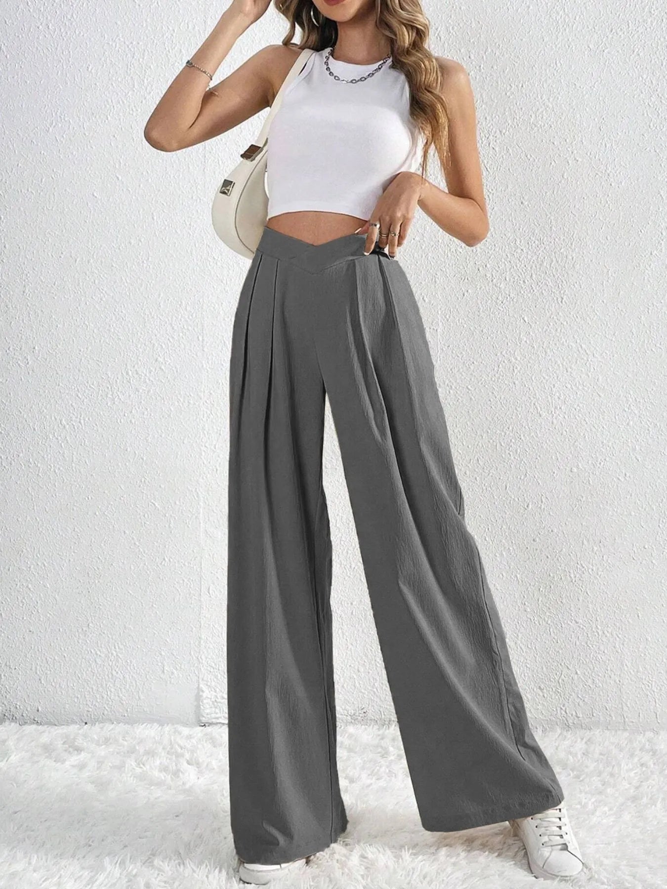 Dark gray wide-leg pants with ruched V-waist and full, wide pant legs