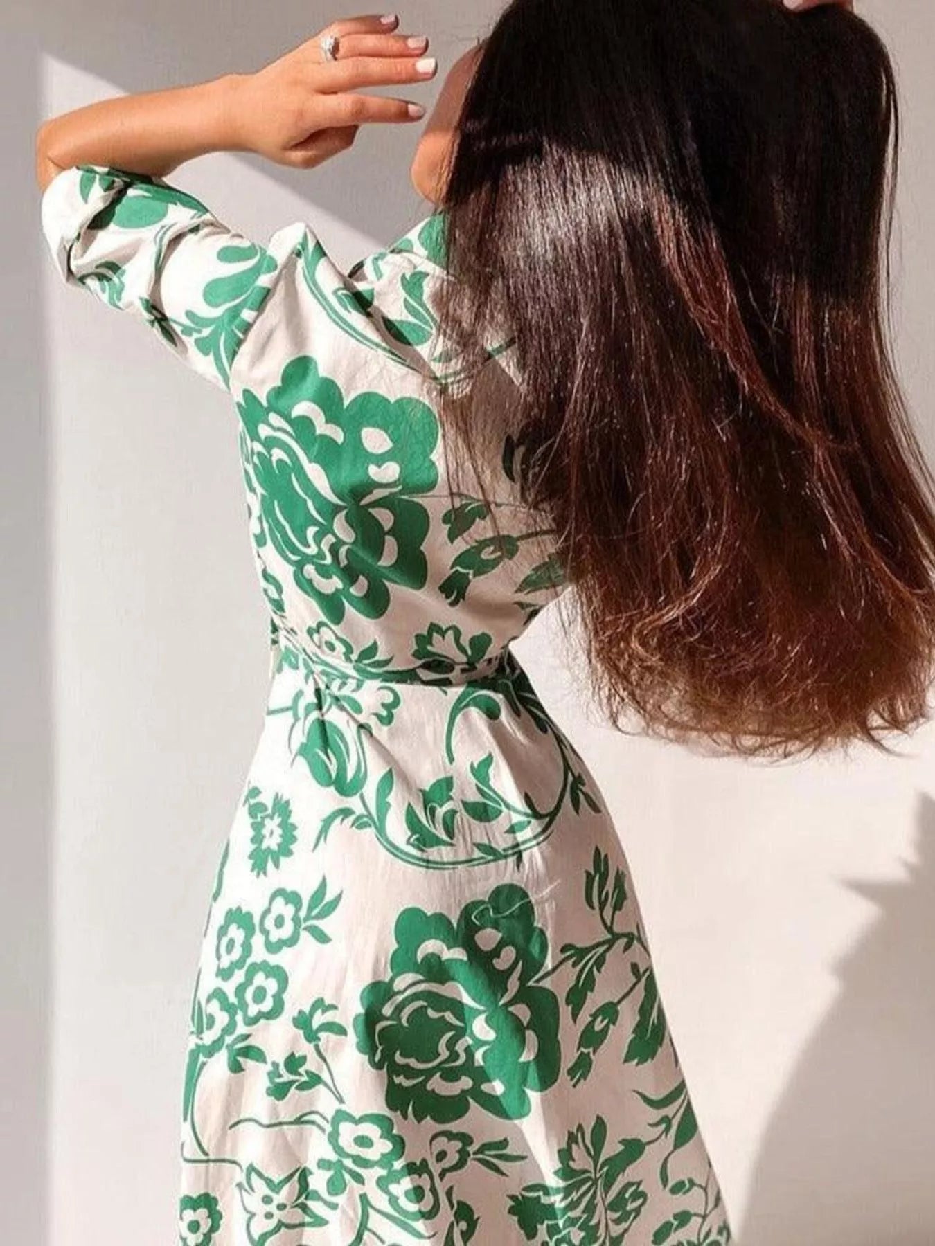 Back view of green floral belted midi dress with 3/4 sleeves
