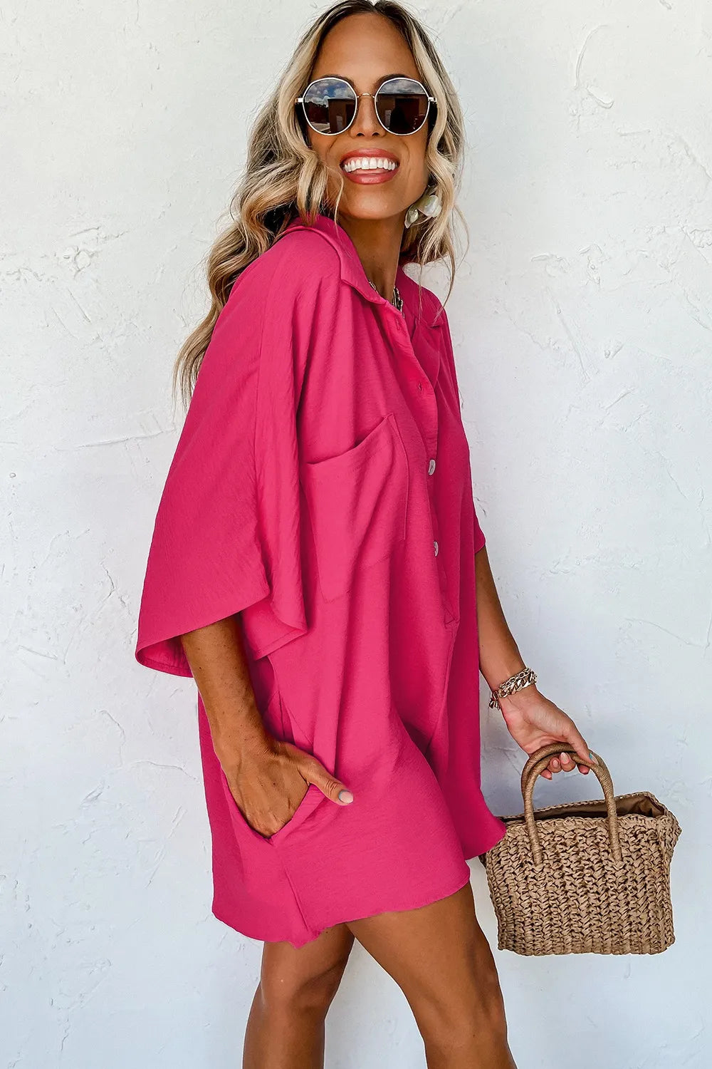 Hot pink half-button collared neck romper with short sleeves and side drape