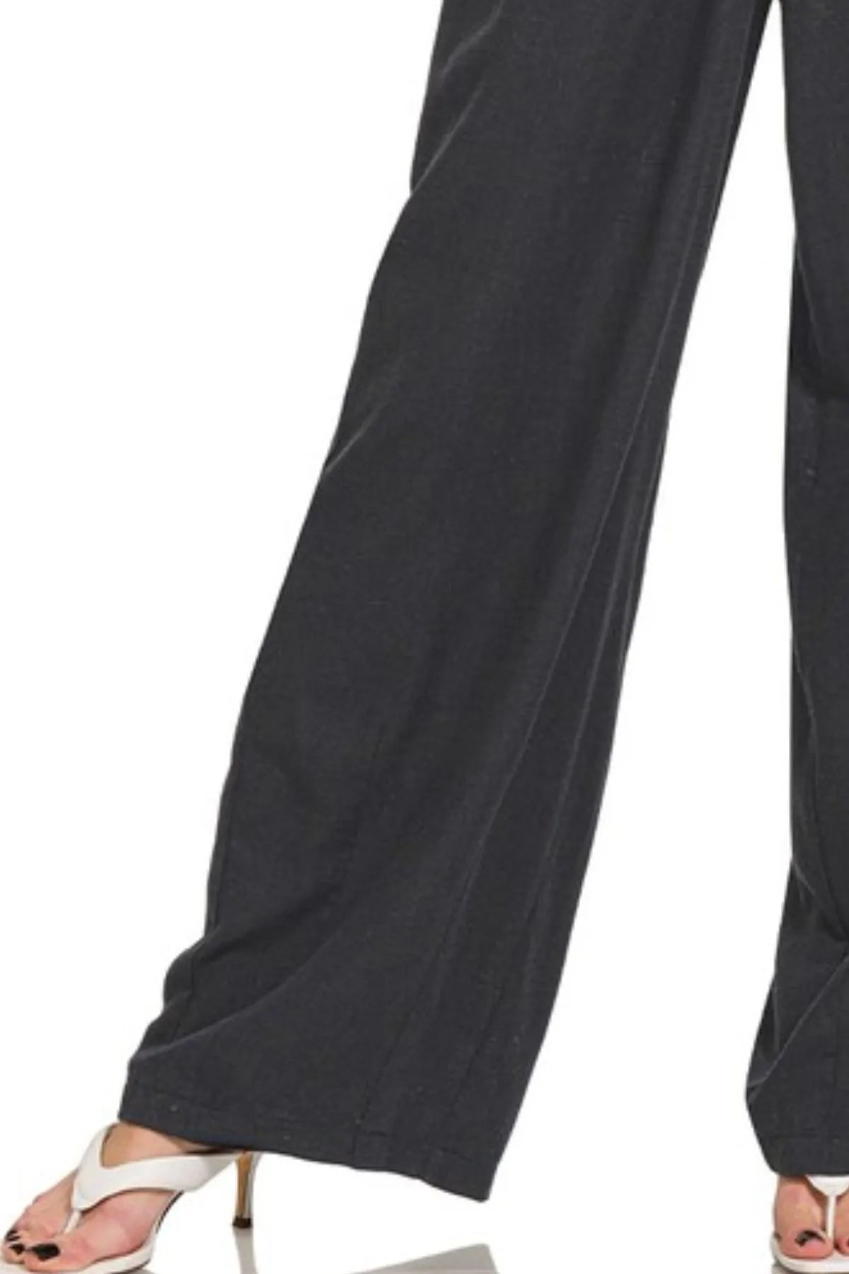 Black linen drawstring pants with loose wide legs and side seam stitching
