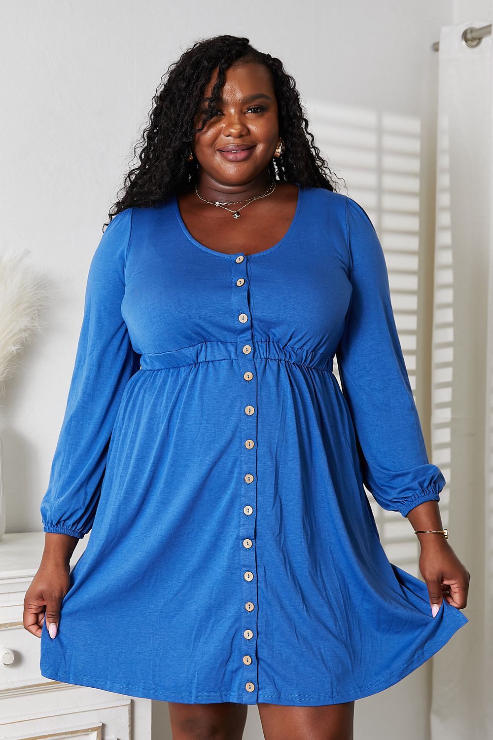 Royal blue long-sleeve scoop-neck empire waist dress with center button placket and gathers