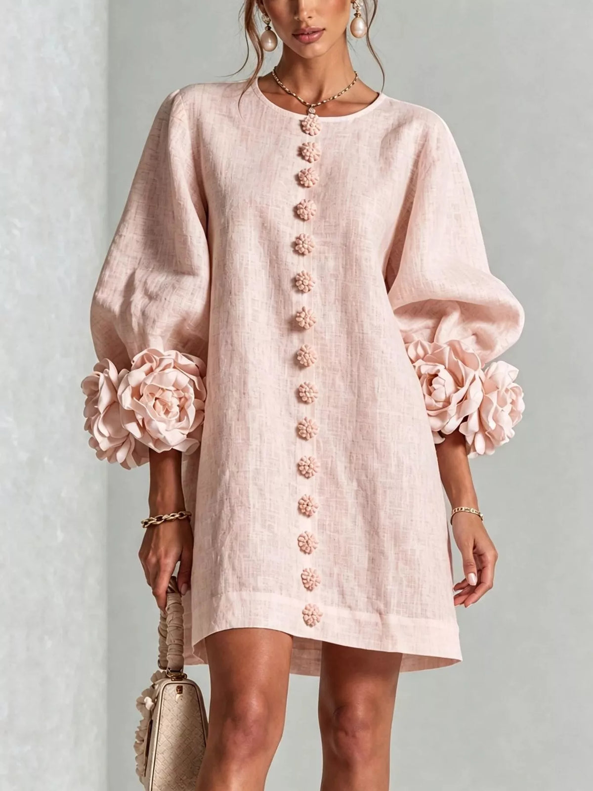 Pink polyester dress with round neck, long sleeves, and 3D floral button trim