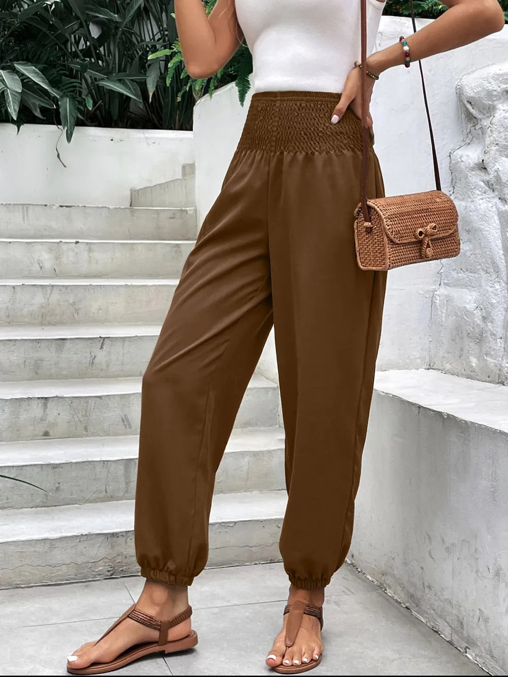 Brown smocked high-rise joggers with side pockets and gathered ankle cuffs