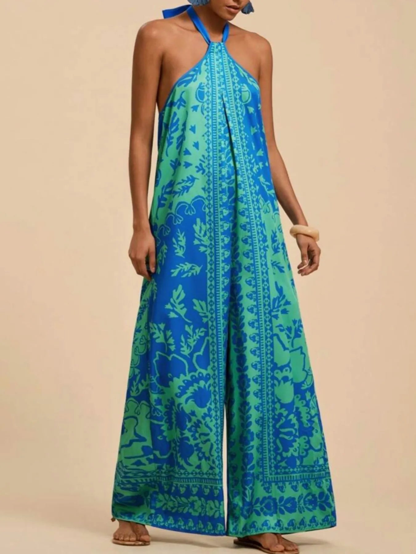 Sky blue halter wide-leg jumpsuit with leafy tile print and halter tie