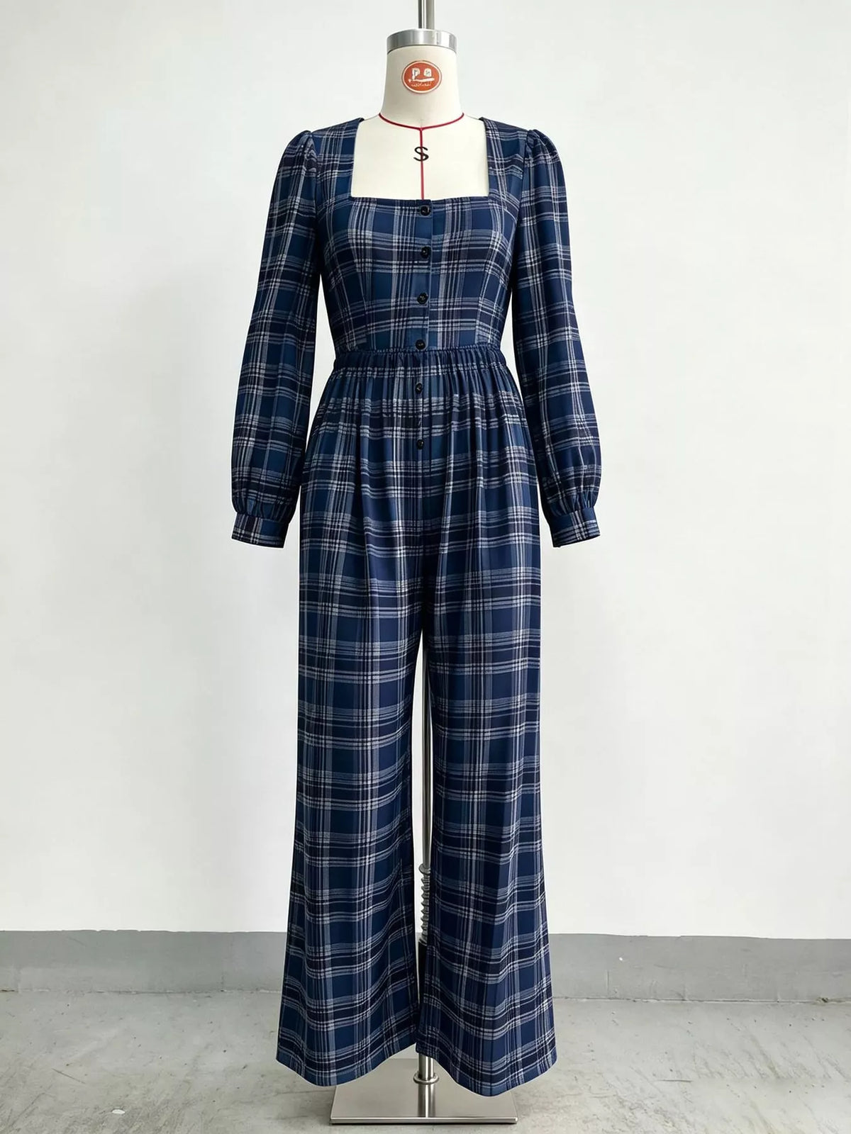 Navy plaid square-neck long-sleeve jumpsuit on mannequin, button front and wide legs