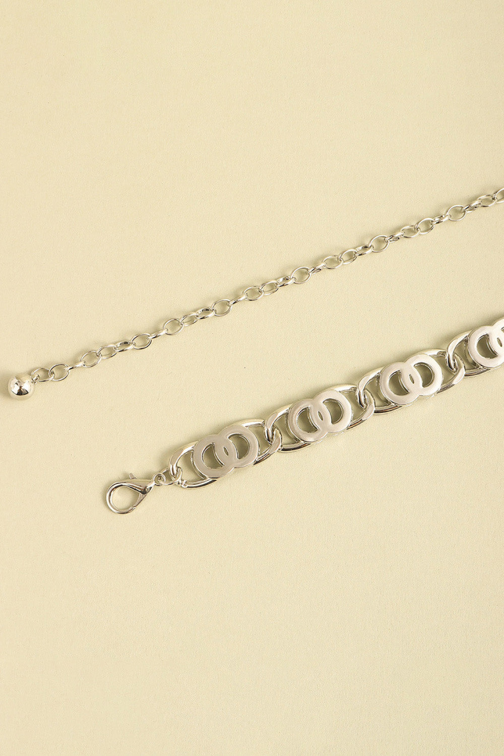 Silver lobster clasp belt detail with ornate oval-link chain and ring clasp end