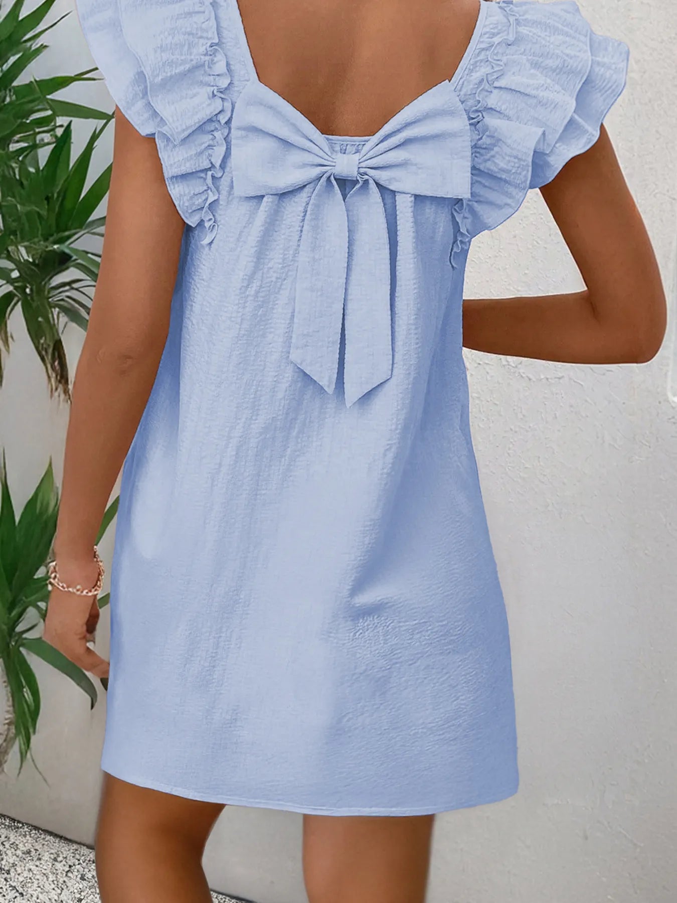 Bow Back Ruffled Sleeve Dress in light blue with a large back bow and ruffled sleeves