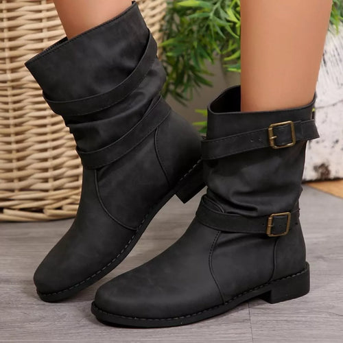 Black buckled low-heel ankle boots with two adjustable straps and square gold buckles