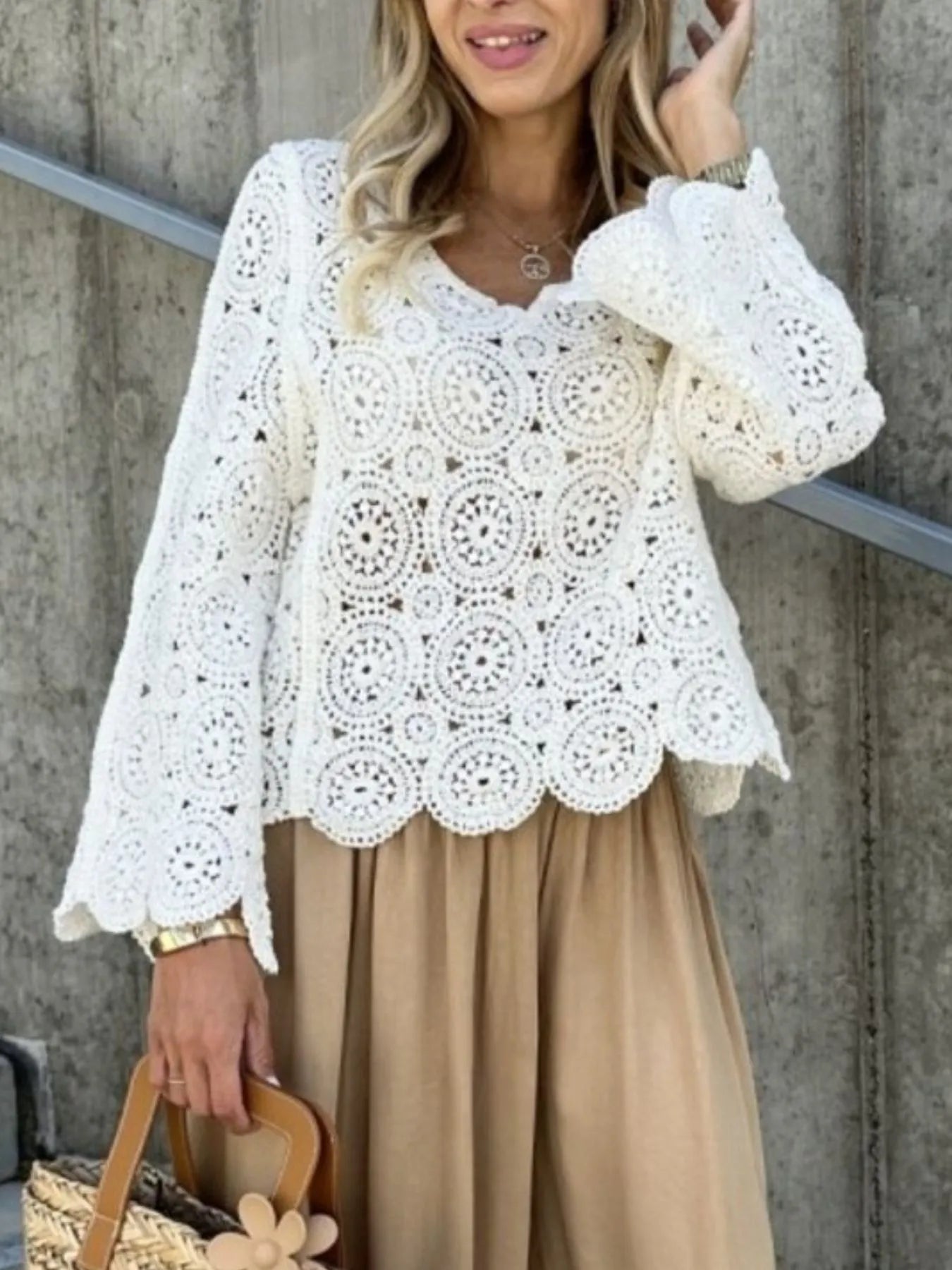 White crochet lace knit top with V-neck and detailed openwork circles, bell sleeves
