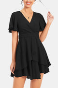 Black surplice V-neck flutter sleeve tiered mini dress with belted waist