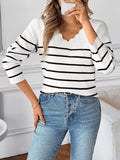 White V-neck long sleeve sweater with bold black horizontal stripes, ribbed knit hem