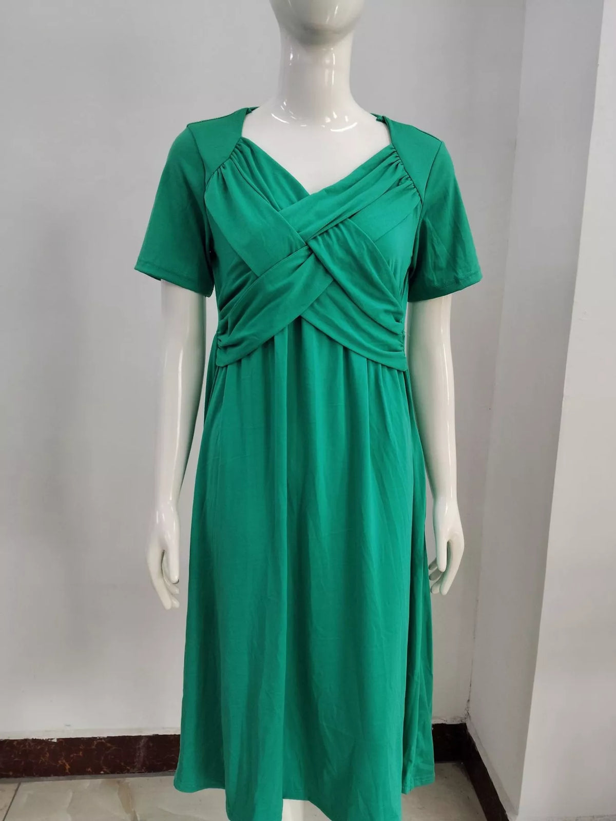 Green crisscross wrap midi dress with gathered waist seam, short sleeves