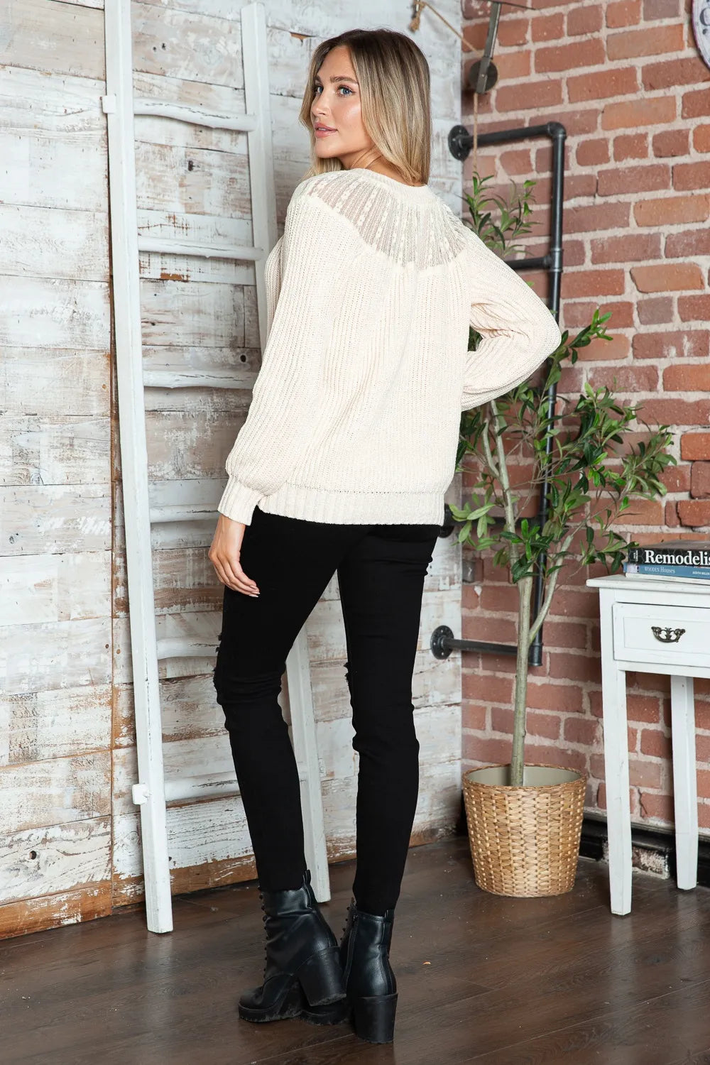 Cream rib-knit sweater from back view with textured yoke stripe detail and ribbed hem