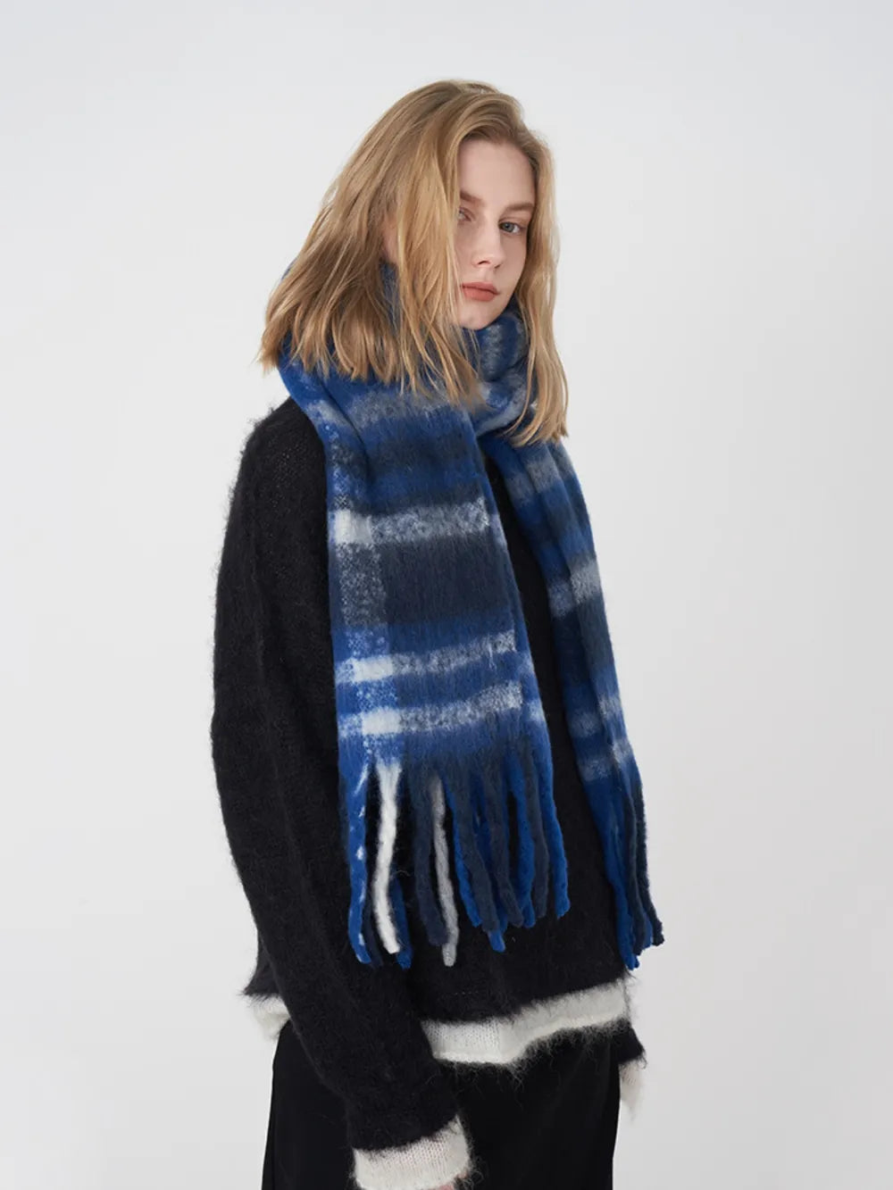 Plaid polyester scarf in blue with light stripes and fringed ends.