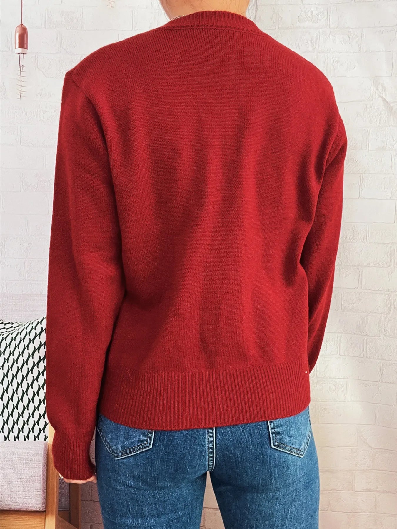 Red knit cardigan back view with long sleeves and ribbed hem