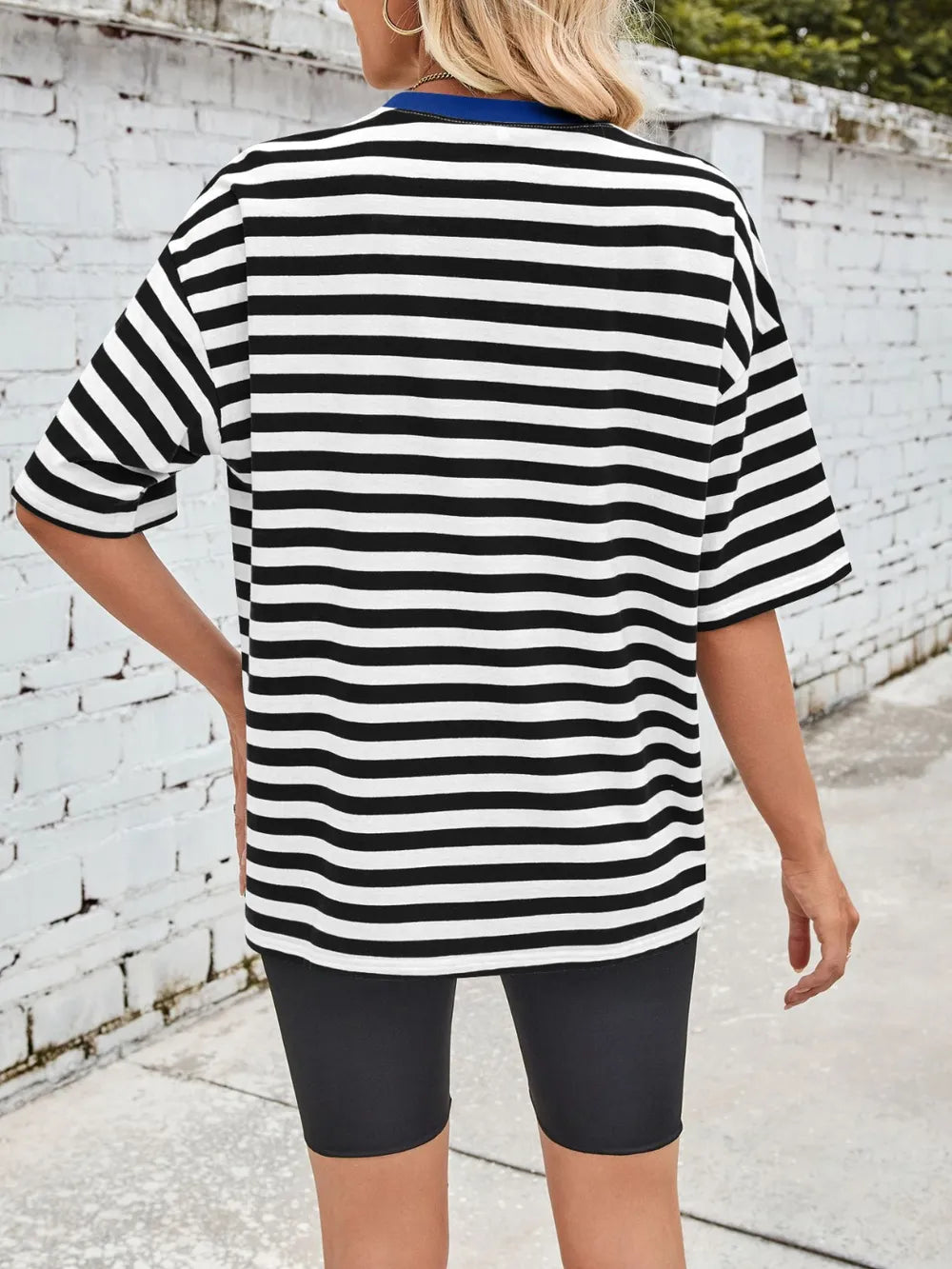 Black striped round-neck half-sleeve T-shirt, loose fit, back view.