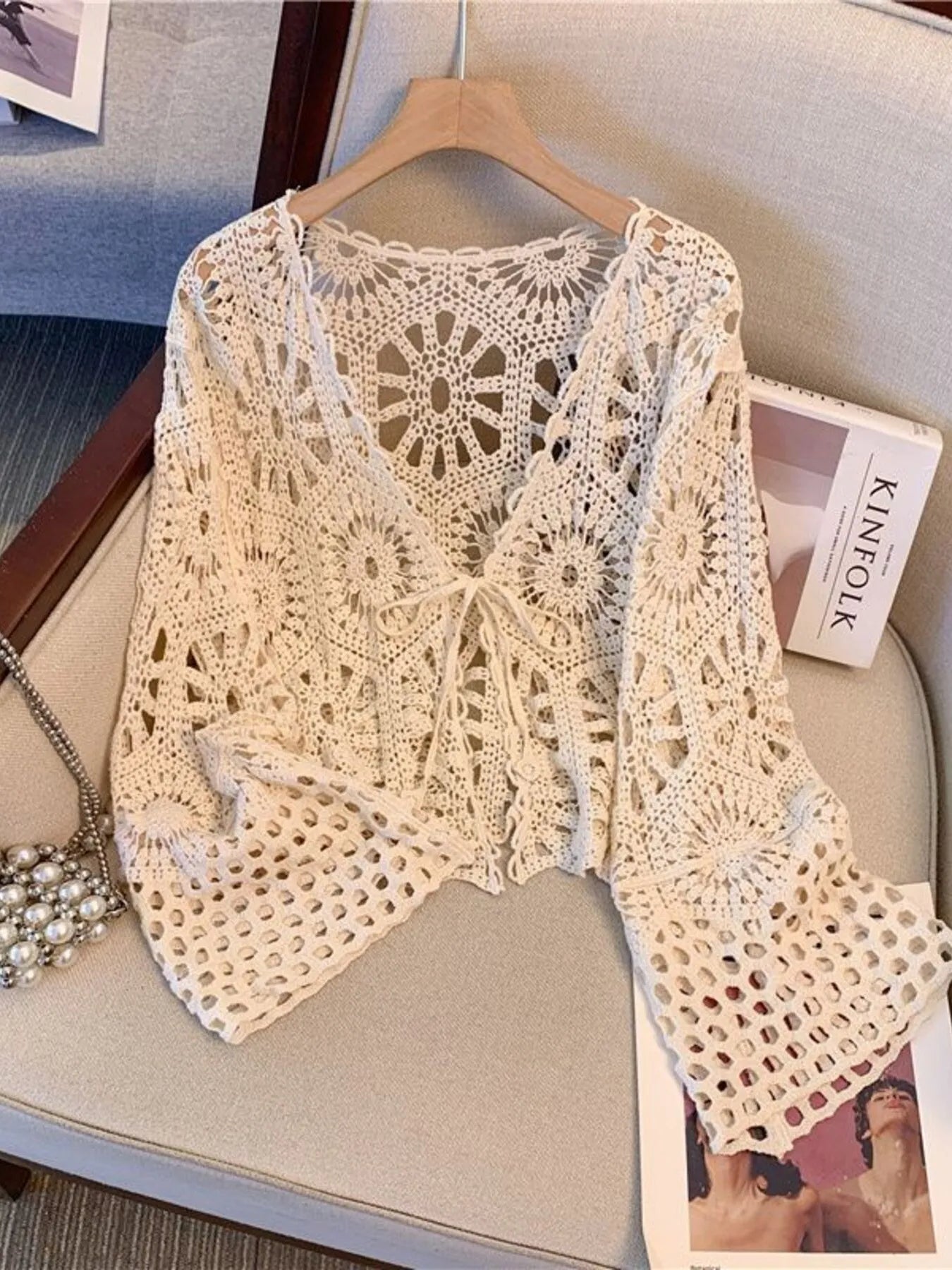 Crochet tie-front cardigan with openwork shell motifs, back view with scalloped hem