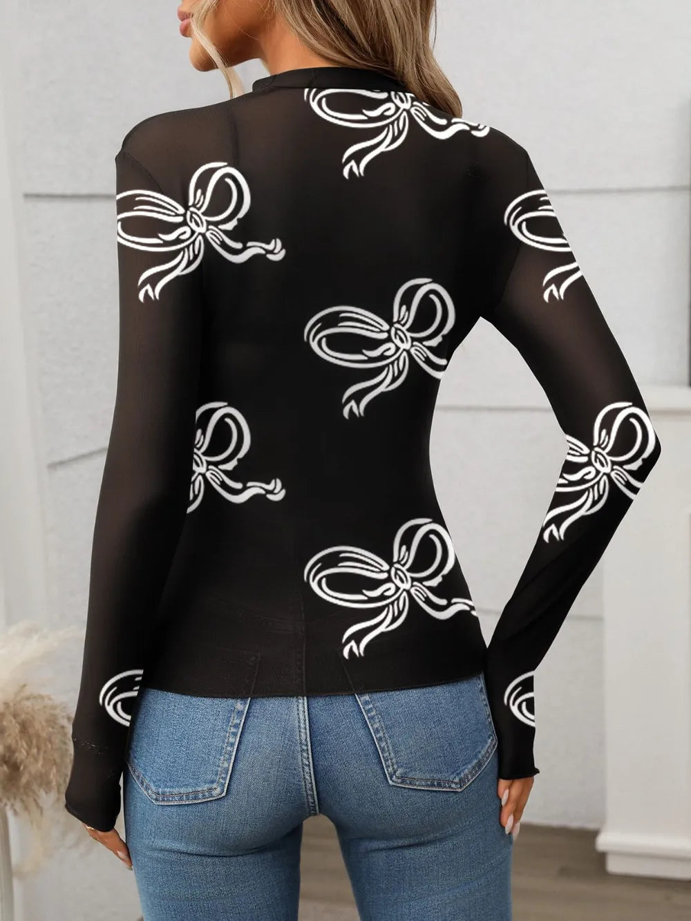 Printed mock neck long sleeve mesh T-shirt, black with white bow print on back.