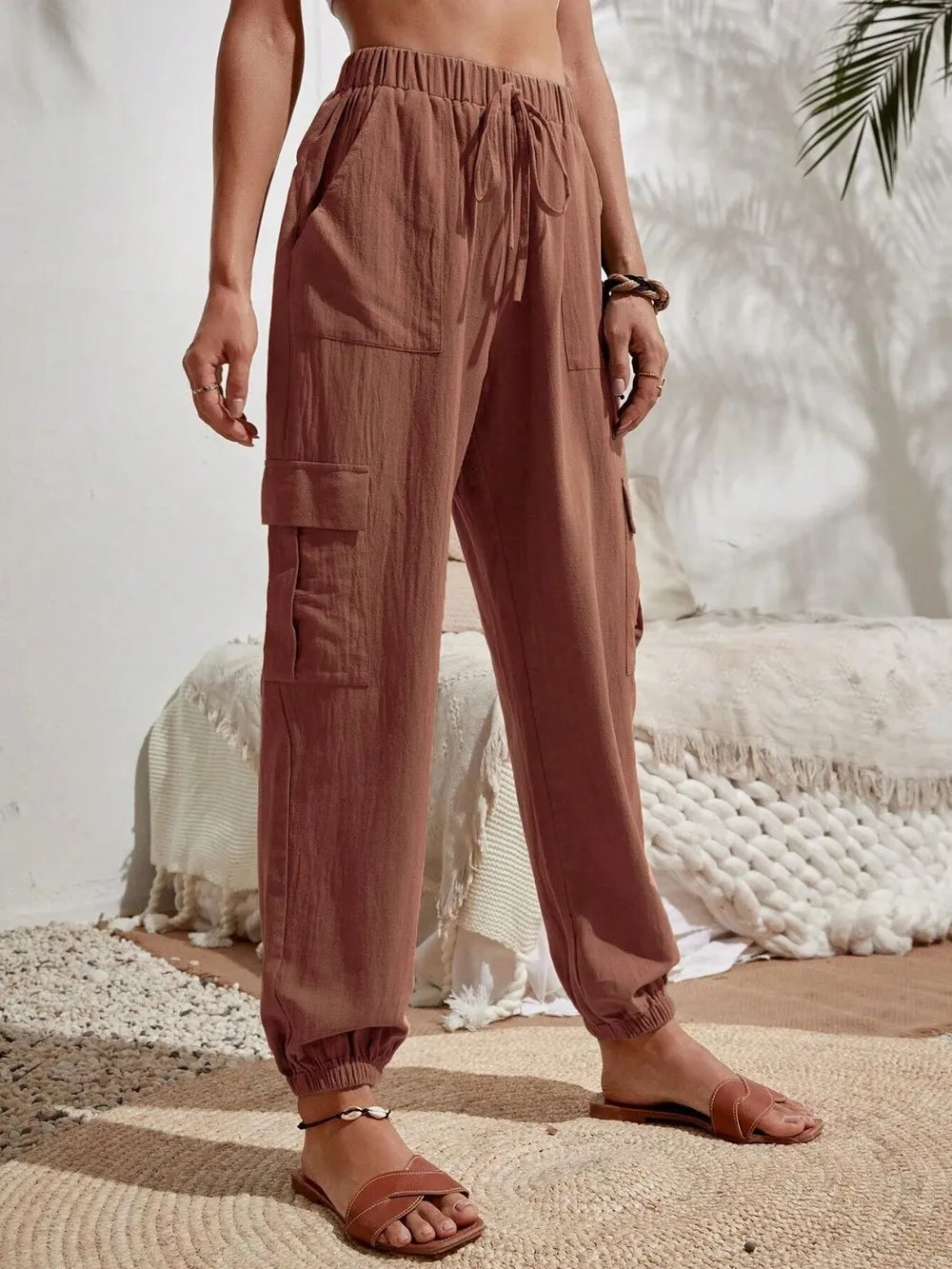 Burgundy drawstring cargo joggers with side cargo pockets and elastic ankle cuffs