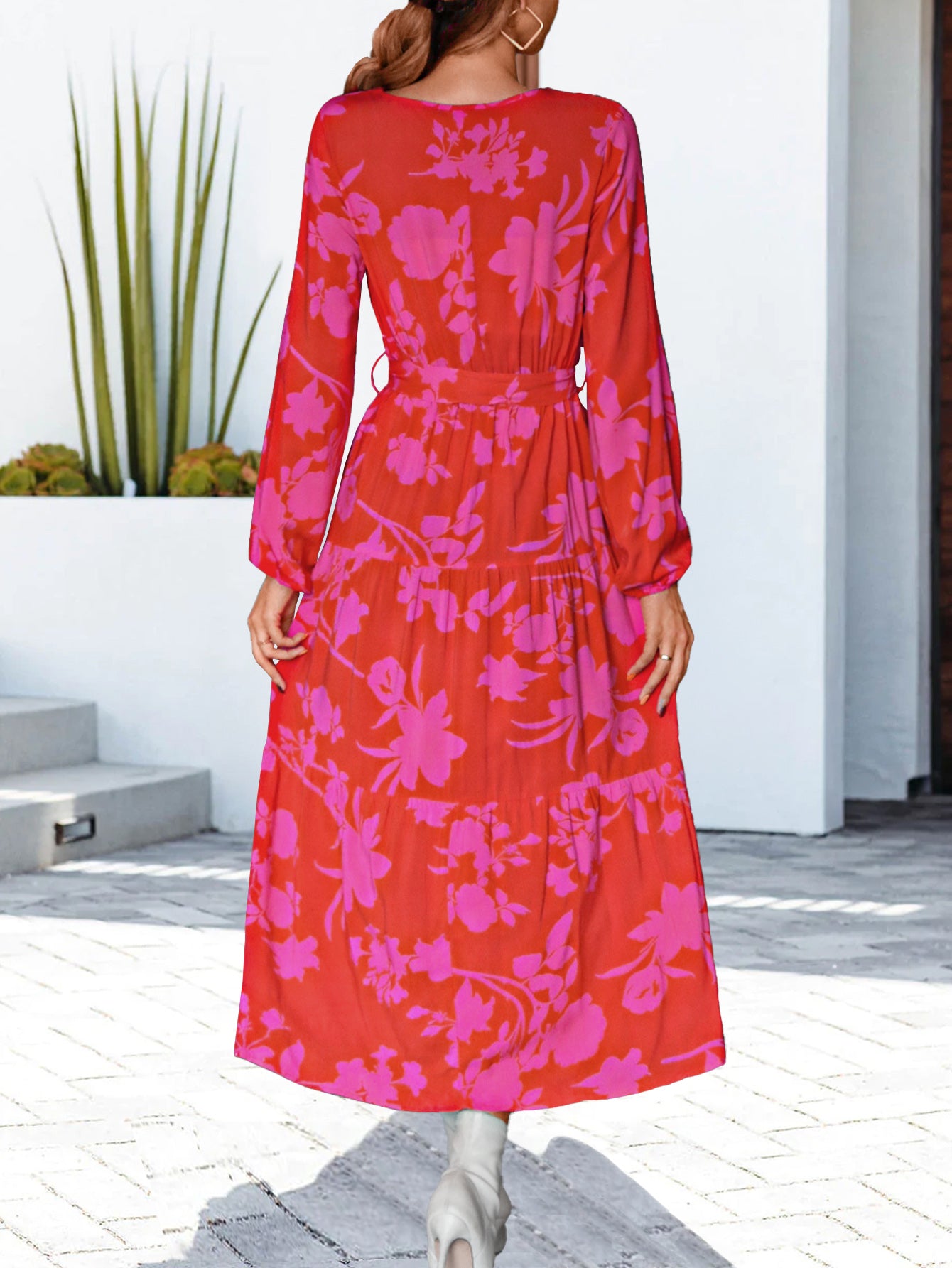 Hot pink floral V-neck long sleeve dress, cinched waist and tiered maxi skirt, back view