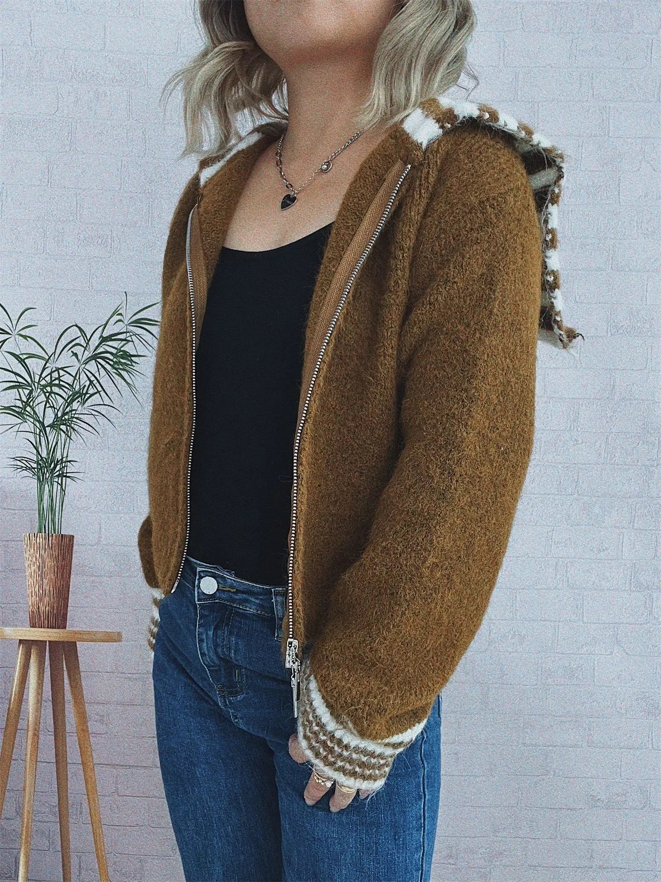 Brown zip-up cardigan with white striped cuffs and fleece trim at zipper