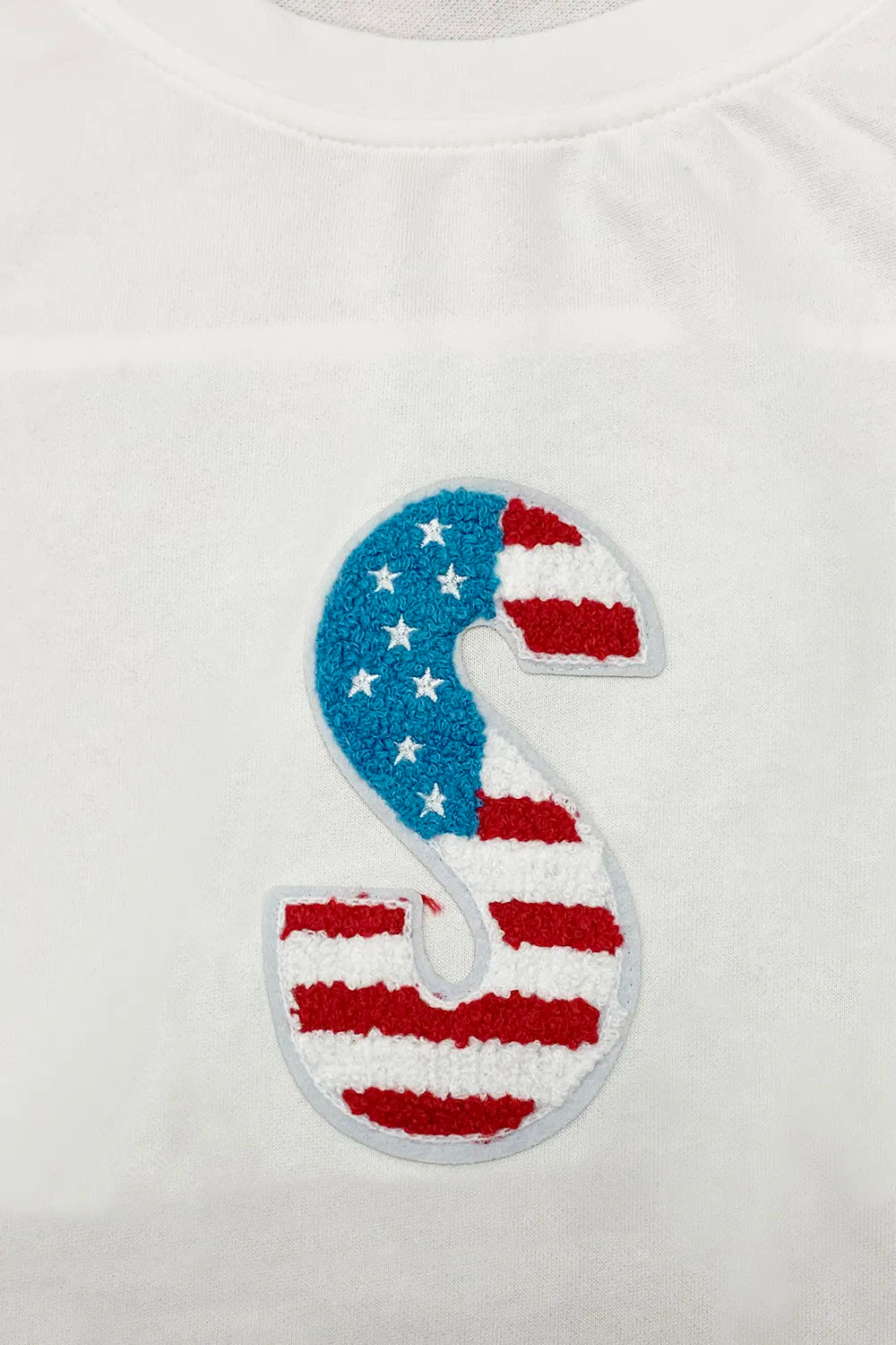 White round neck short sleeve T-shirt with embroidered-style blue and red 'S' graphic