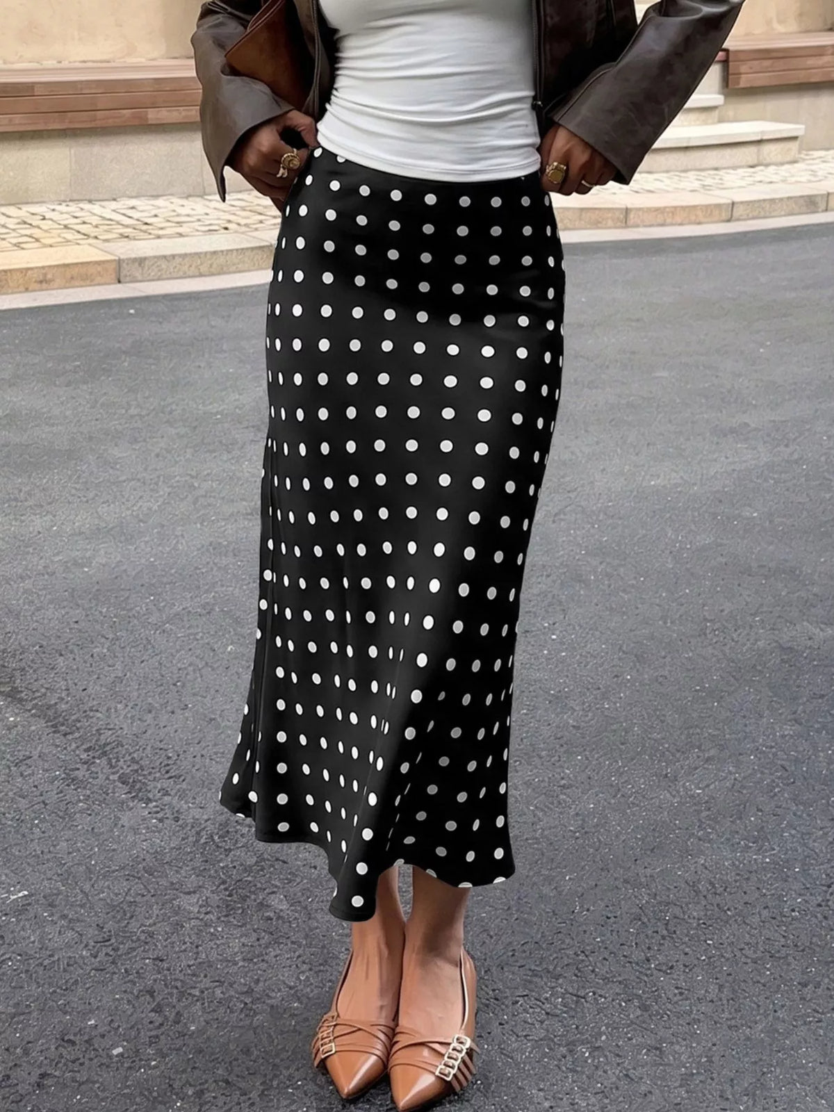 Black midi skirt with white polka dots and elastic waistband, flowing fit
