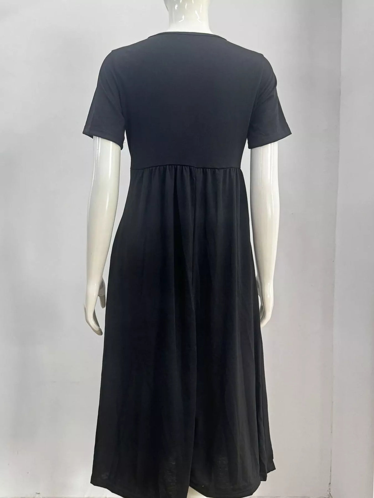 Dark midi dress with gathered waist seam and short sleeves, back view