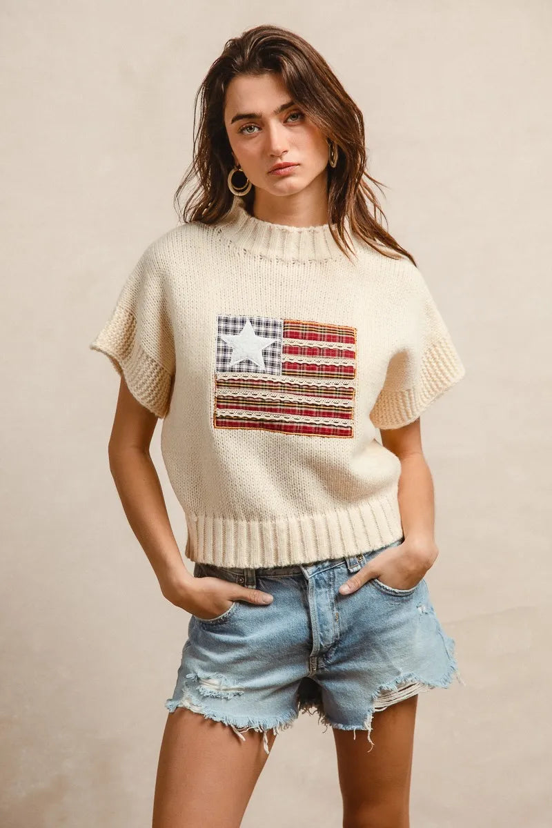 Oatmeal knit sweater with American flag patch on chest, short sleeves, crew neck