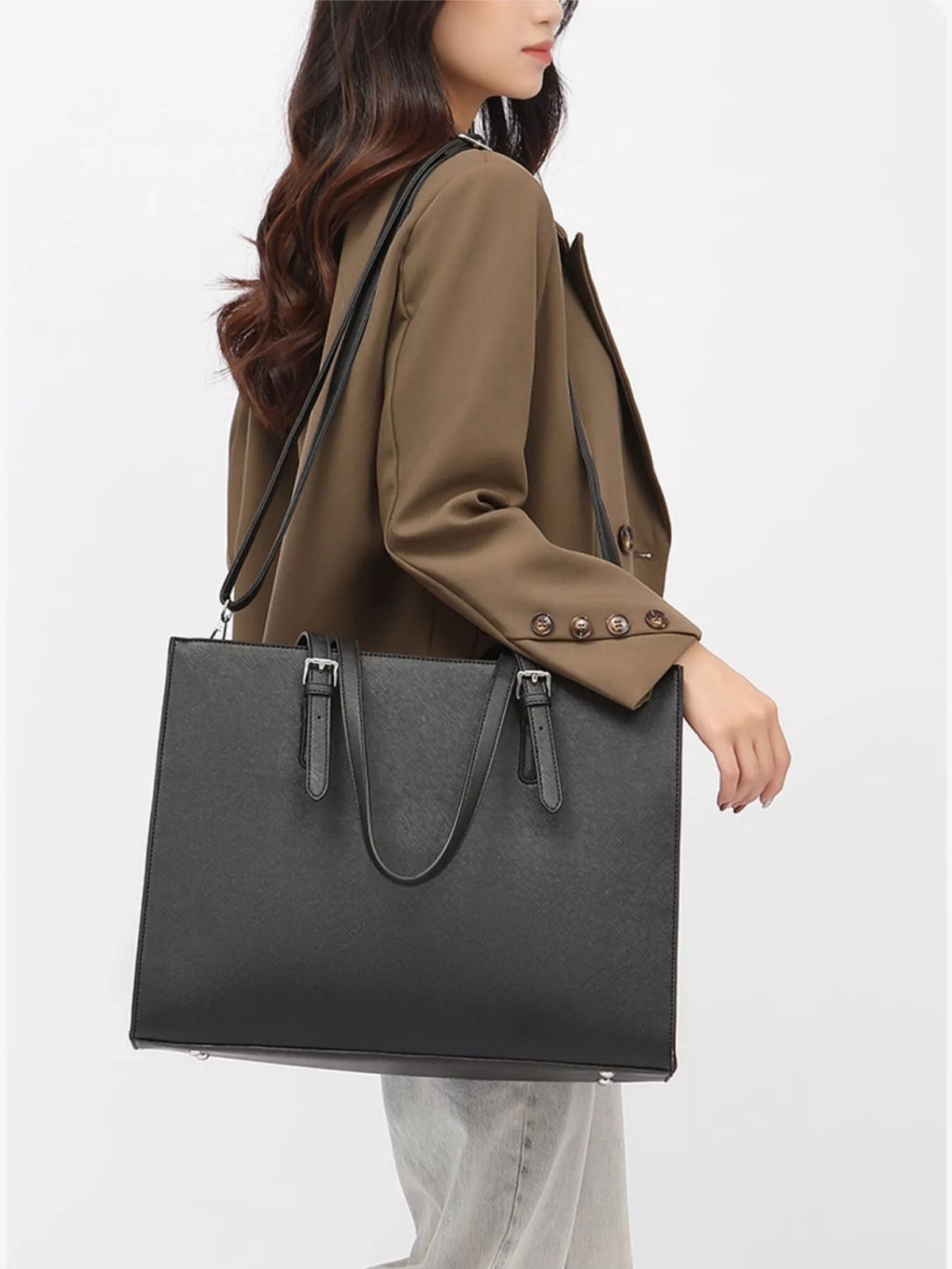 Black large vegan leather tote bag with dual top handles and open top.