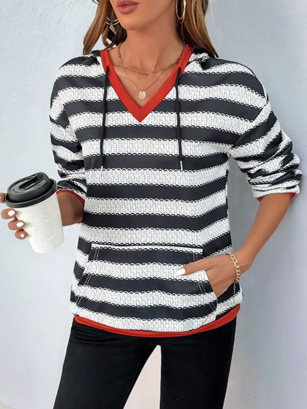 Contrast striped long sleeve hoodie with red V-neck trim and black-and-white stripes