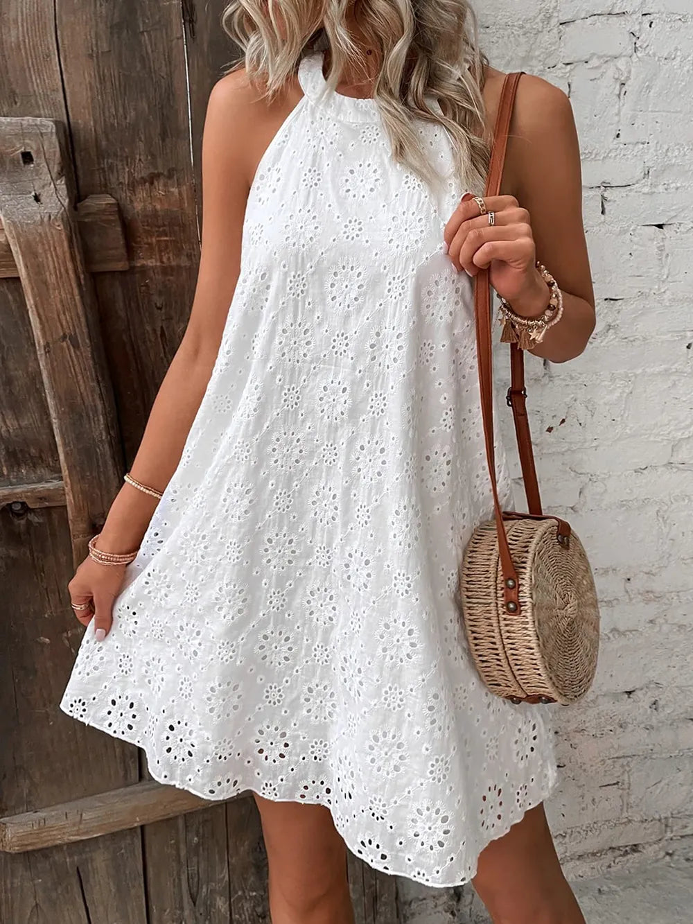 White eyelet mini dress with high halter neckline and A-line flared skirt