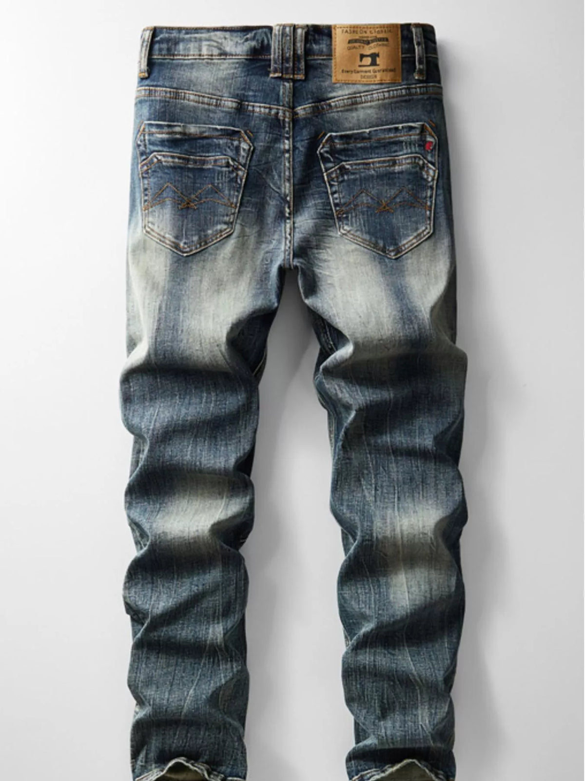 Men's slim-fit vintage wash denim jeans, back pockets and waistband with stitched seams