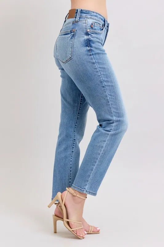 Light blue slim jeans from the side view with back yoke and cropped ankle hem