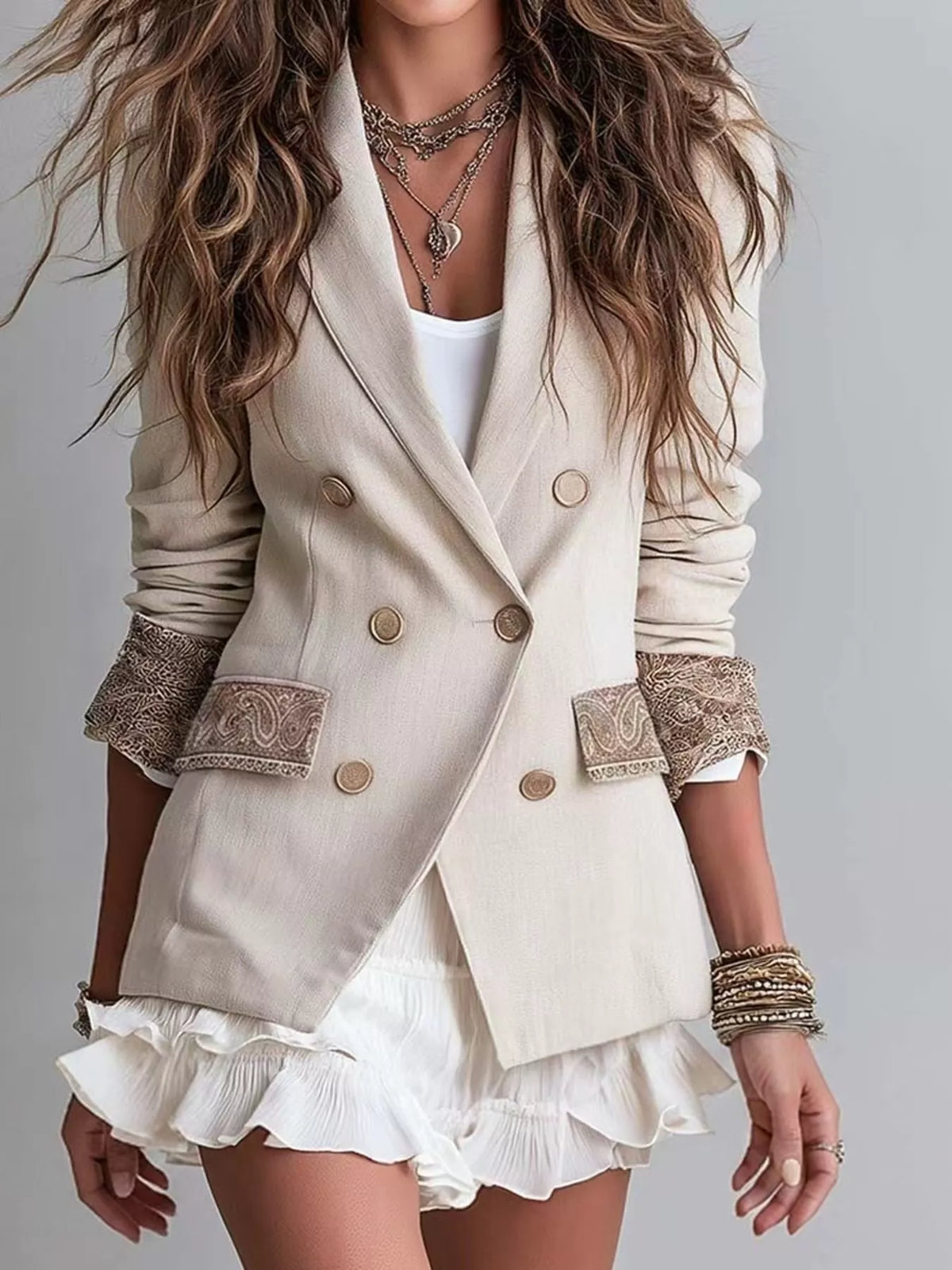 Cream double-breasted blazer with lapel, gold buttons, lace-trim cuffs, ruffled hem